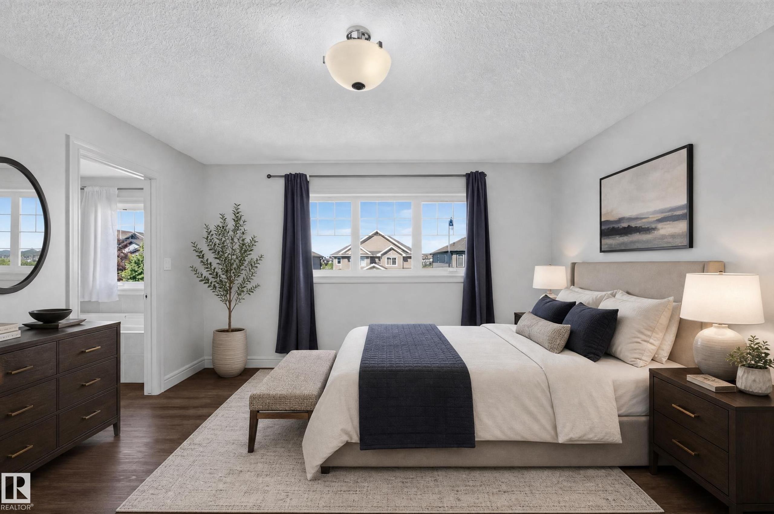 Spacious bedroom featuring wood-finish flooring, a contemporary ceiling light fixture, and a multi-pane window with dark drapery - 1346 Cunningham Drive, Edmonton, AB