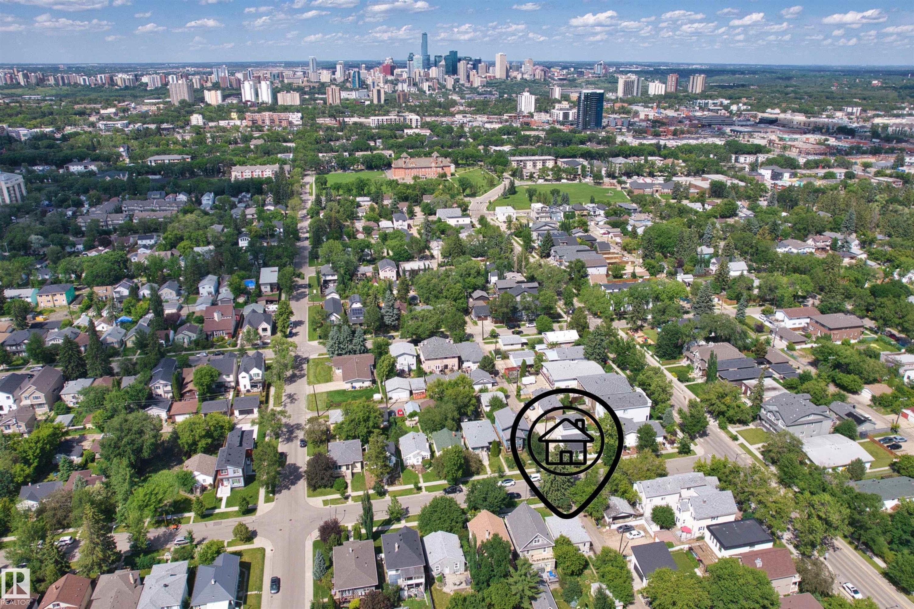 Aerial perspective of a residential neighborhood with a distant cityscape - 10607 73 Ave, Edmonton, AB