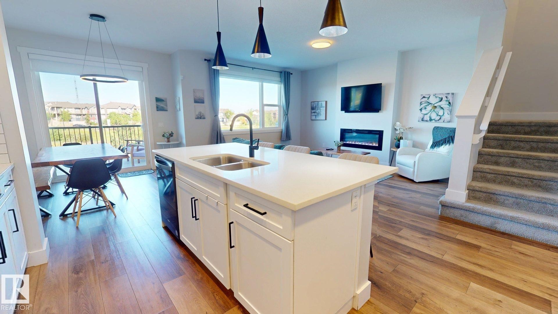 3805 Cherry Loop Sw, Edmonton, AB - Indoor Photo Showing Kitchen With Fireplace With Double Sink