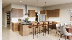 Open-concept kitchen featuring an island with seating, stainless steel appliances, a tile backsplash, wood-finish cabinetry, and recessed lighting -