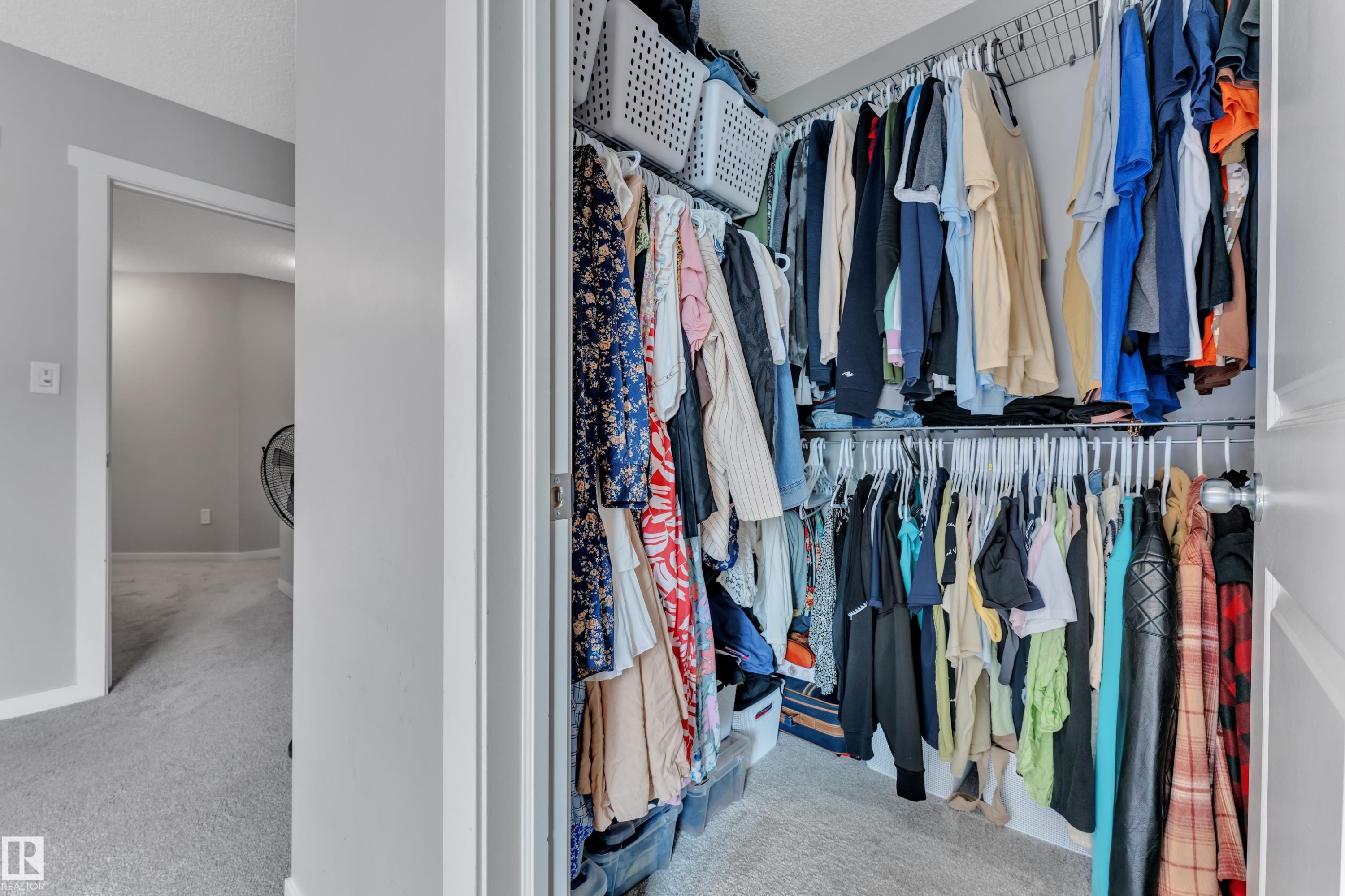 Wardrobe closet featuring wire shelving and double hanging rods - #82 1816 Rutherford Rd Sw, Edmonton, AB - Indoor With Storage