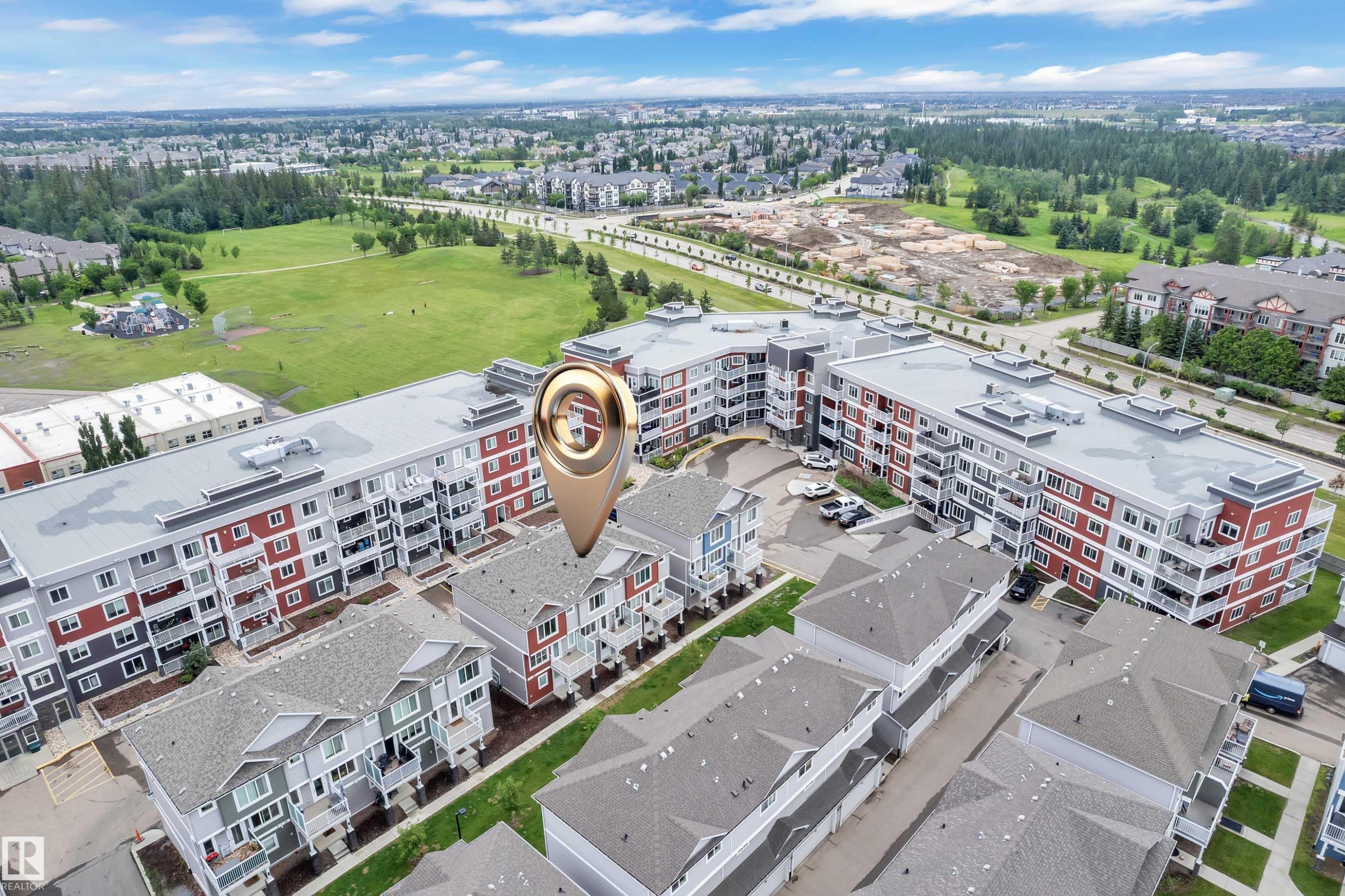 Aerial view showcasing multi-story residential buildings with balconies and townhome-style residences - #82 1816 Rutherford Rd Sw, Edmonton, AB - Outdoor With View