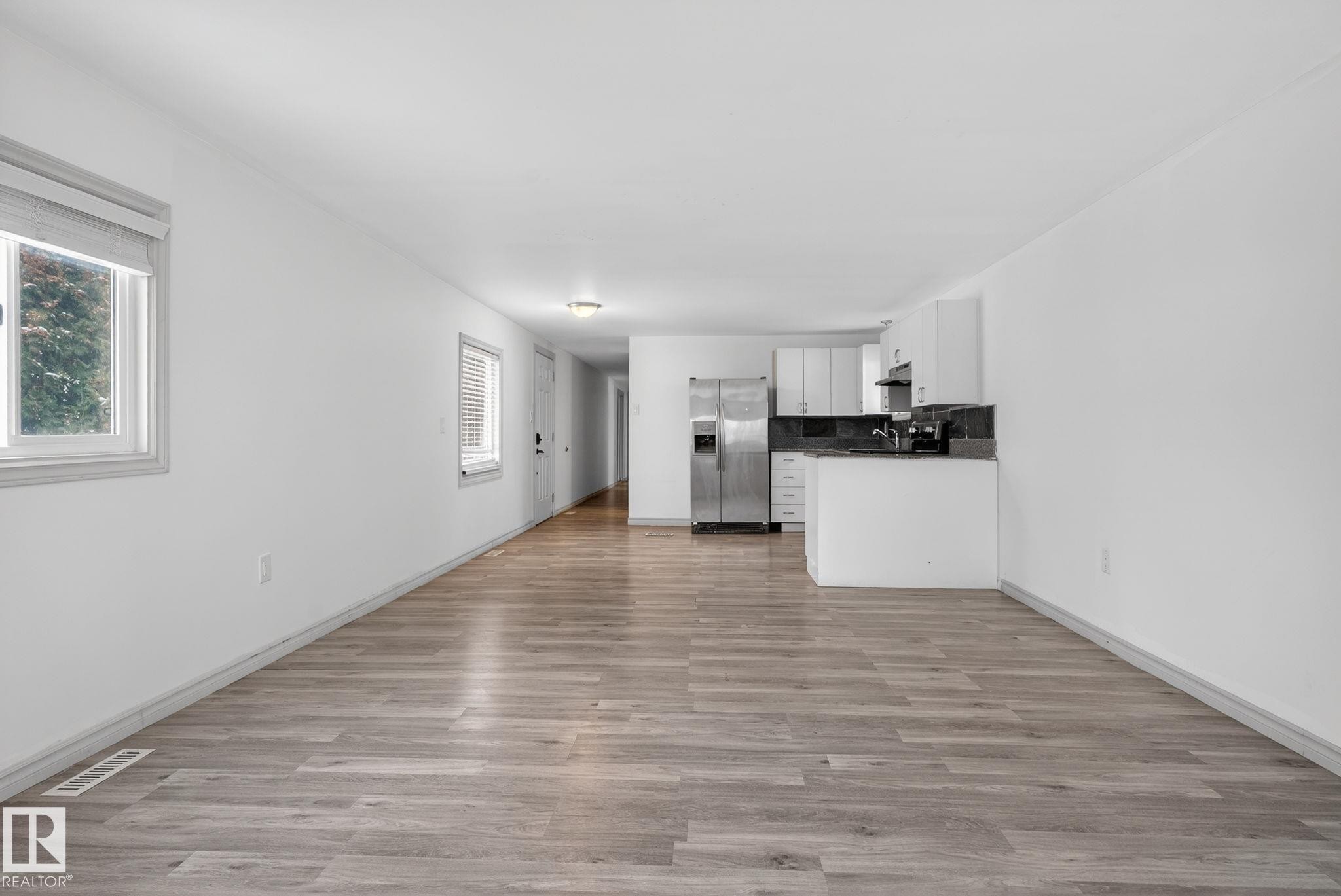 Expansive room with wood-finish flooring and white walls - 543 Evergreen Park Northwest, Edmonton, AB - Indoor Photo Showing Kitchen