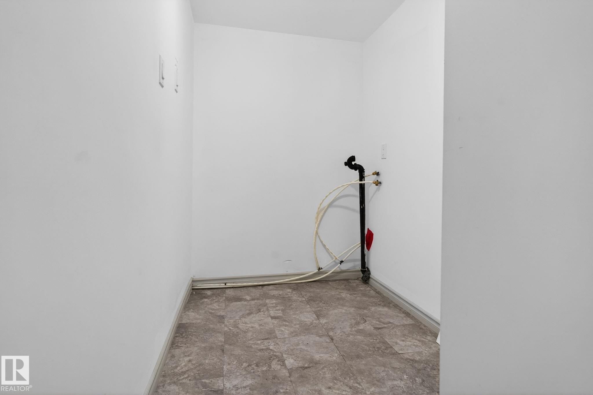 Utility room featuring a tiled floor, white walls, and plumbing connections for appliances - 543 Evergreen Park Northwest, Edmonton, AB - Indoor Photo Showing Other Room