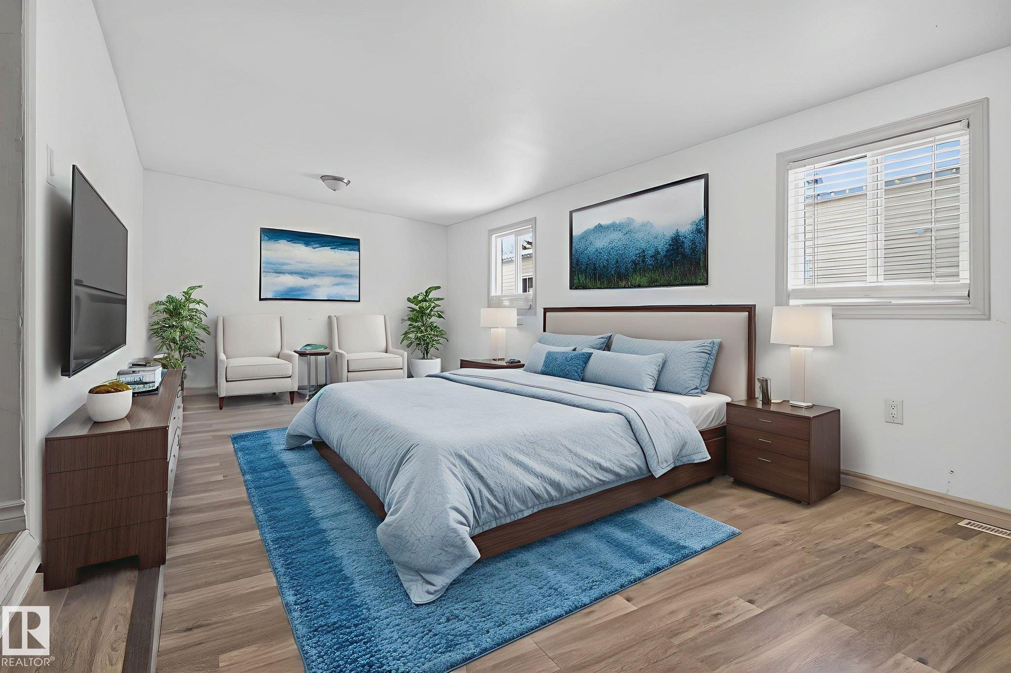 Spacious room featuring wood-finish flooring, white walls, and multiple windows with blinds - 543 Evergreen Park Northwest, Edmonton, AB - Indoor Photo Showing Bedroom