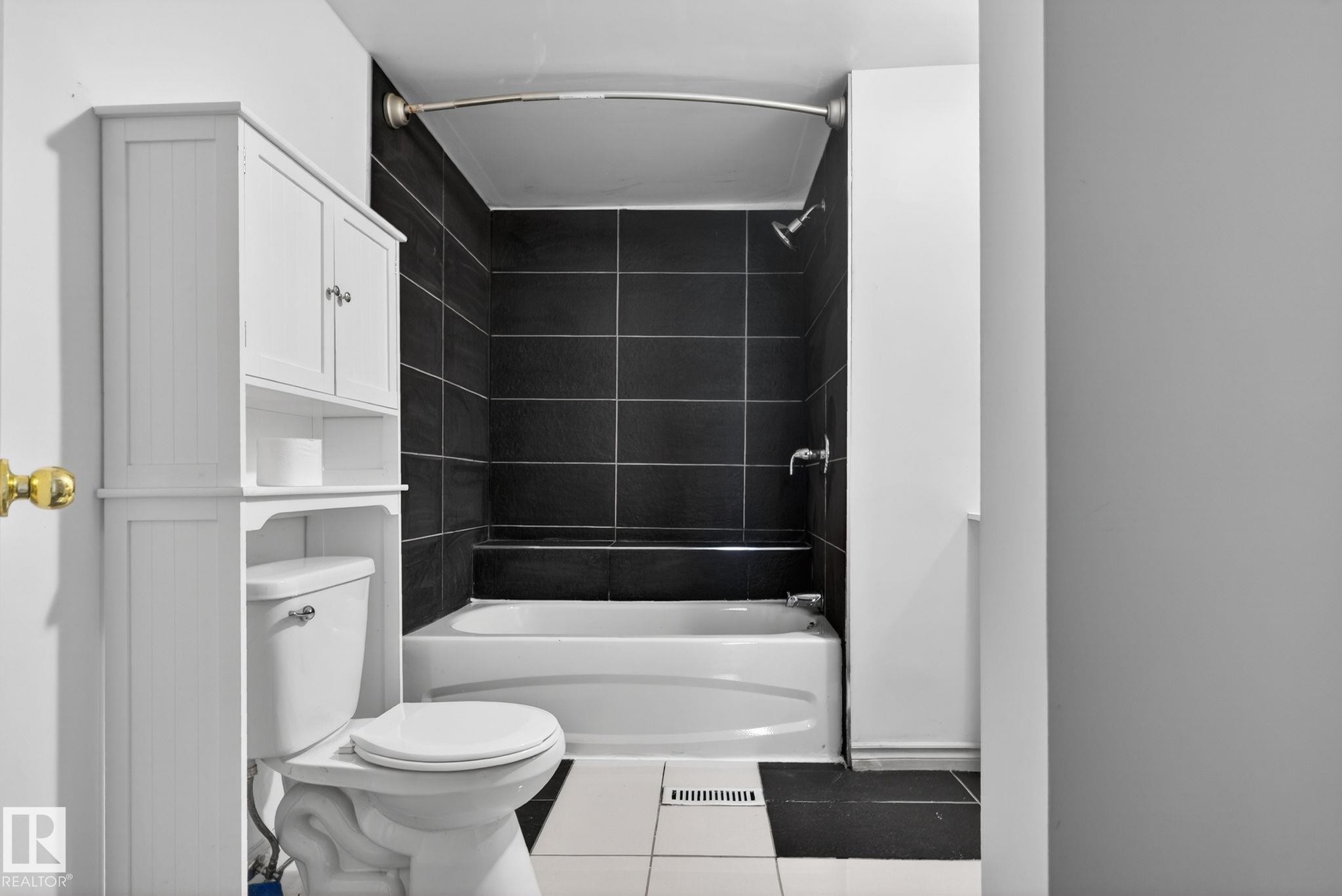 Full bathroom featuring a white bathtub with a black tiled shower surround - 543 Evergreen Park Northwest, Edmonton, AB - Indoor Photo Showing Bathroom