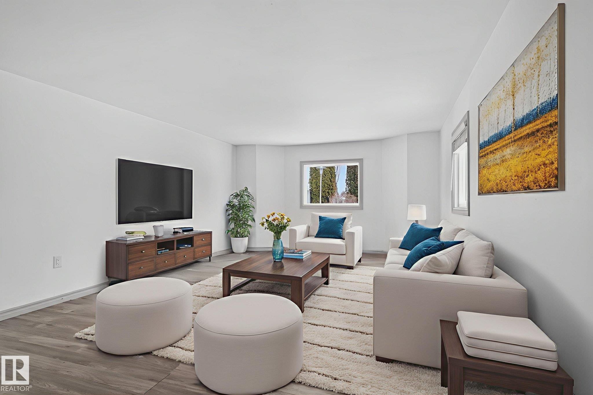 Spacious living area featuring light-toned walls, wood-finish flooring, and a large window with white trim - 543 Evergreen Park Northwest, Edmonton, AB - Indoor Photo Showing Living Room