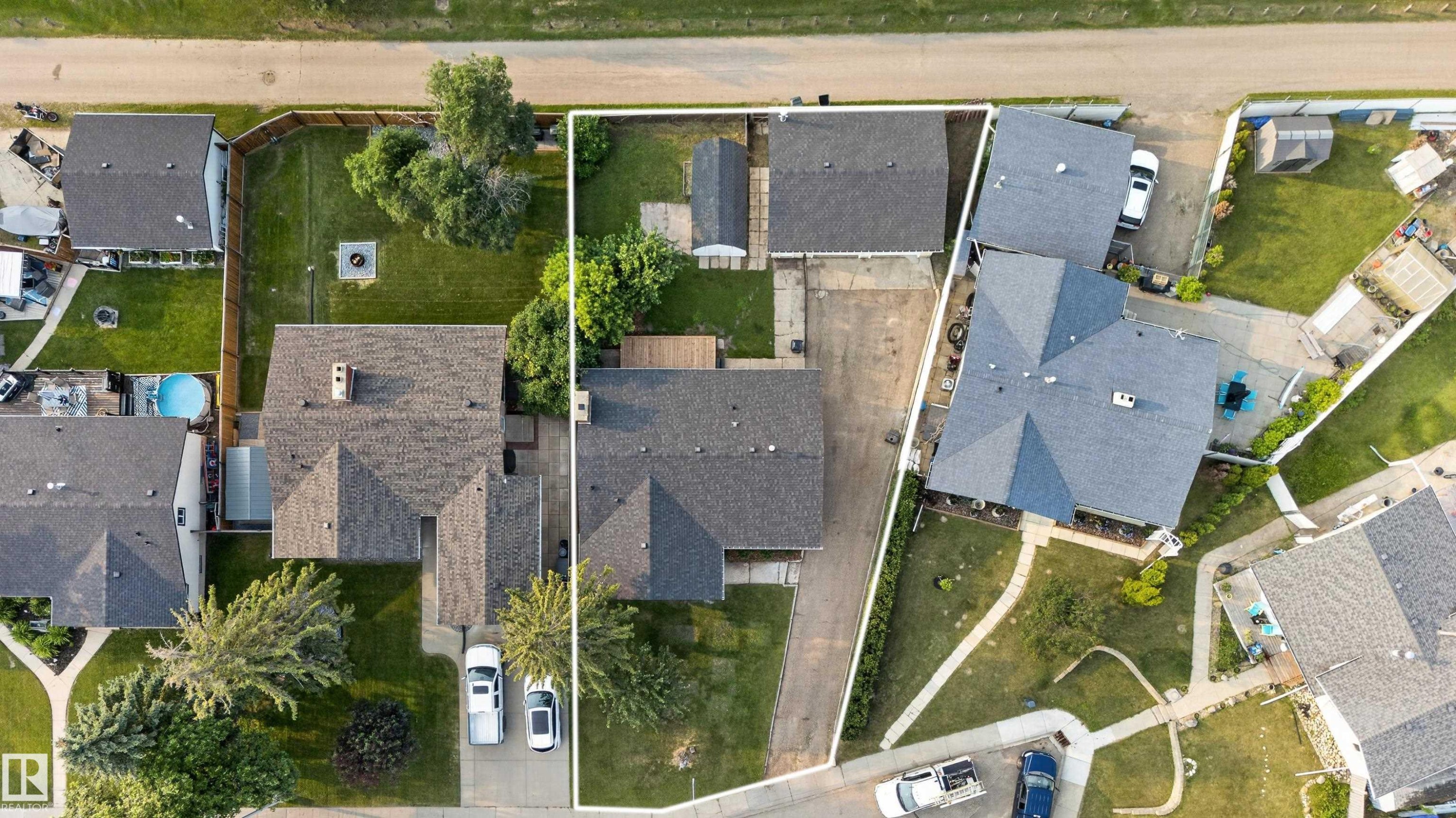 Aerial view highlighting two distinct properties - 33 Brookside Avenue, Spruce Grove, AB