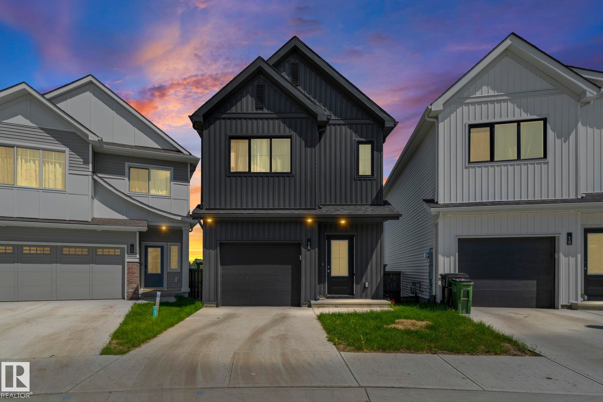 Contemporary exterior featuring dark vertical siding and a prominent gable roofline - 16 19904 31 Avenue, Edmonton, AB