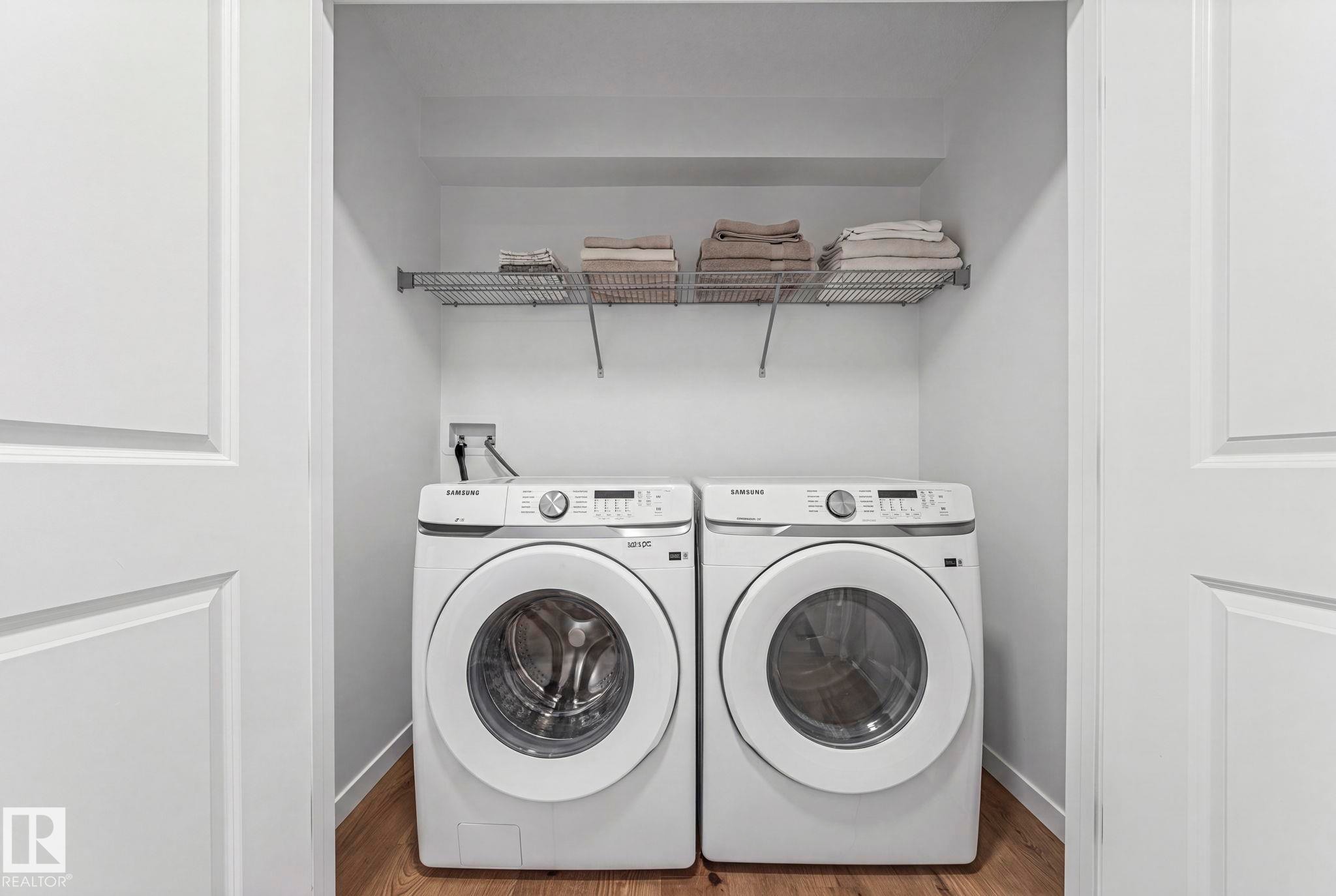 Dedicated laundry area featuring a white front-loading washer and dryer set - 16 19904 31 Avenue, Edmonton, AB