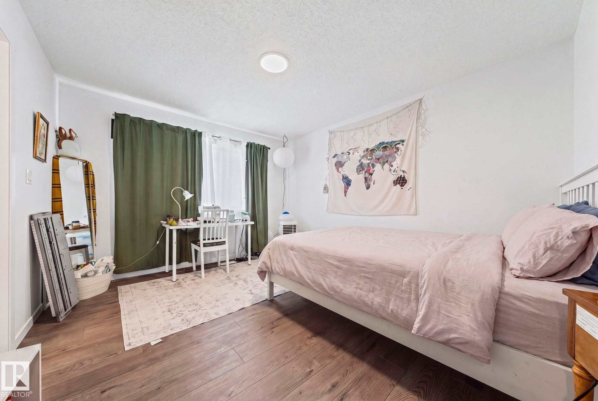 Room featuring wood-finish flooring, white walls, and a recessed ceiling light - 16 19904 31 Avenue, Edmonton, AB