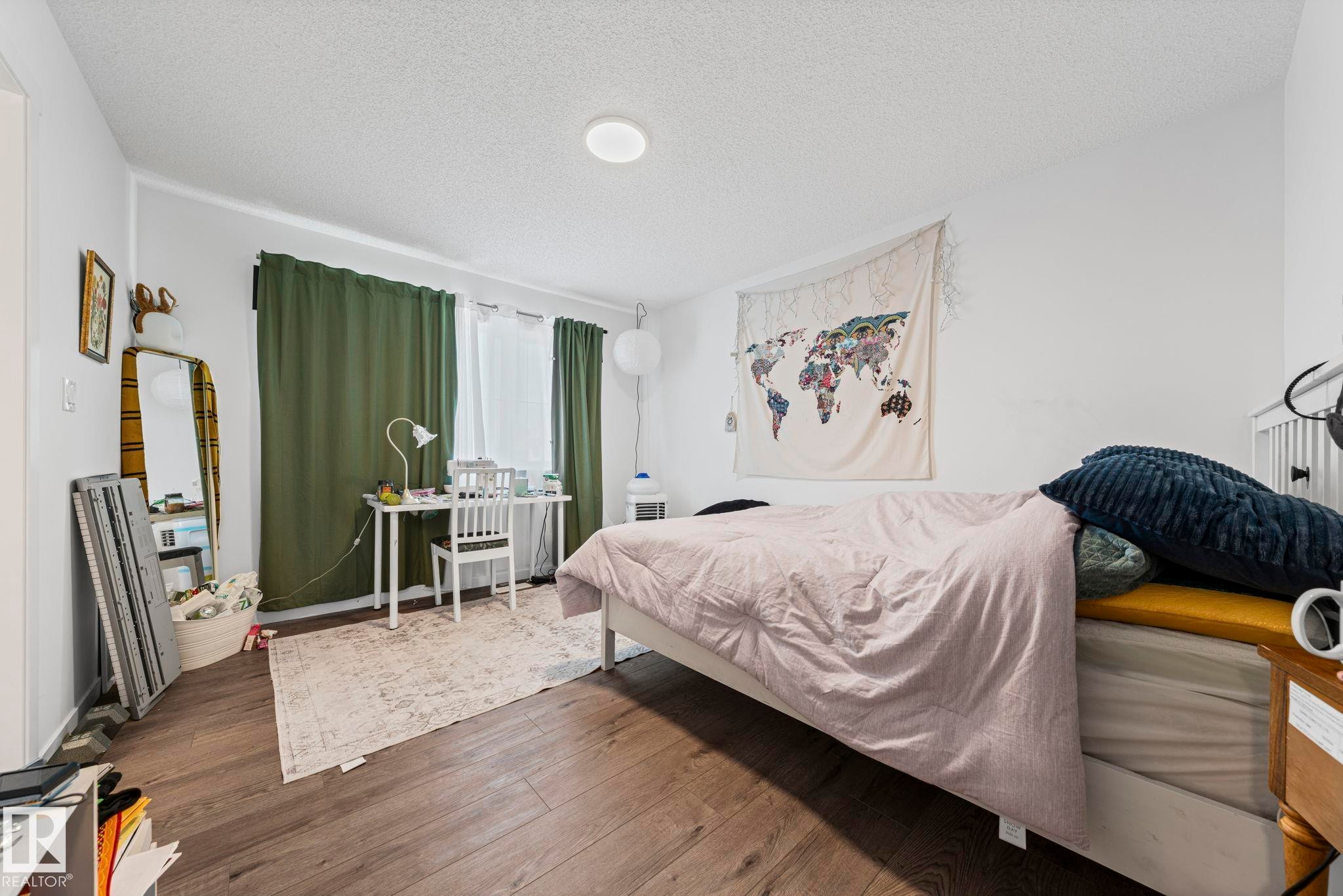 Room featuring wood-finish flooring and white walls - 16 19904 31 Avenue, Edmonton, AB