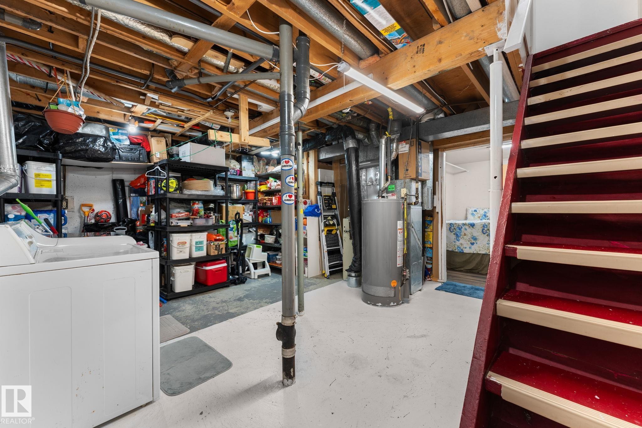 Utility space featuring exposed ceiling joists, a water heater, and a laundry appliance - 359 Northgate Terrace, Edmonton, AB