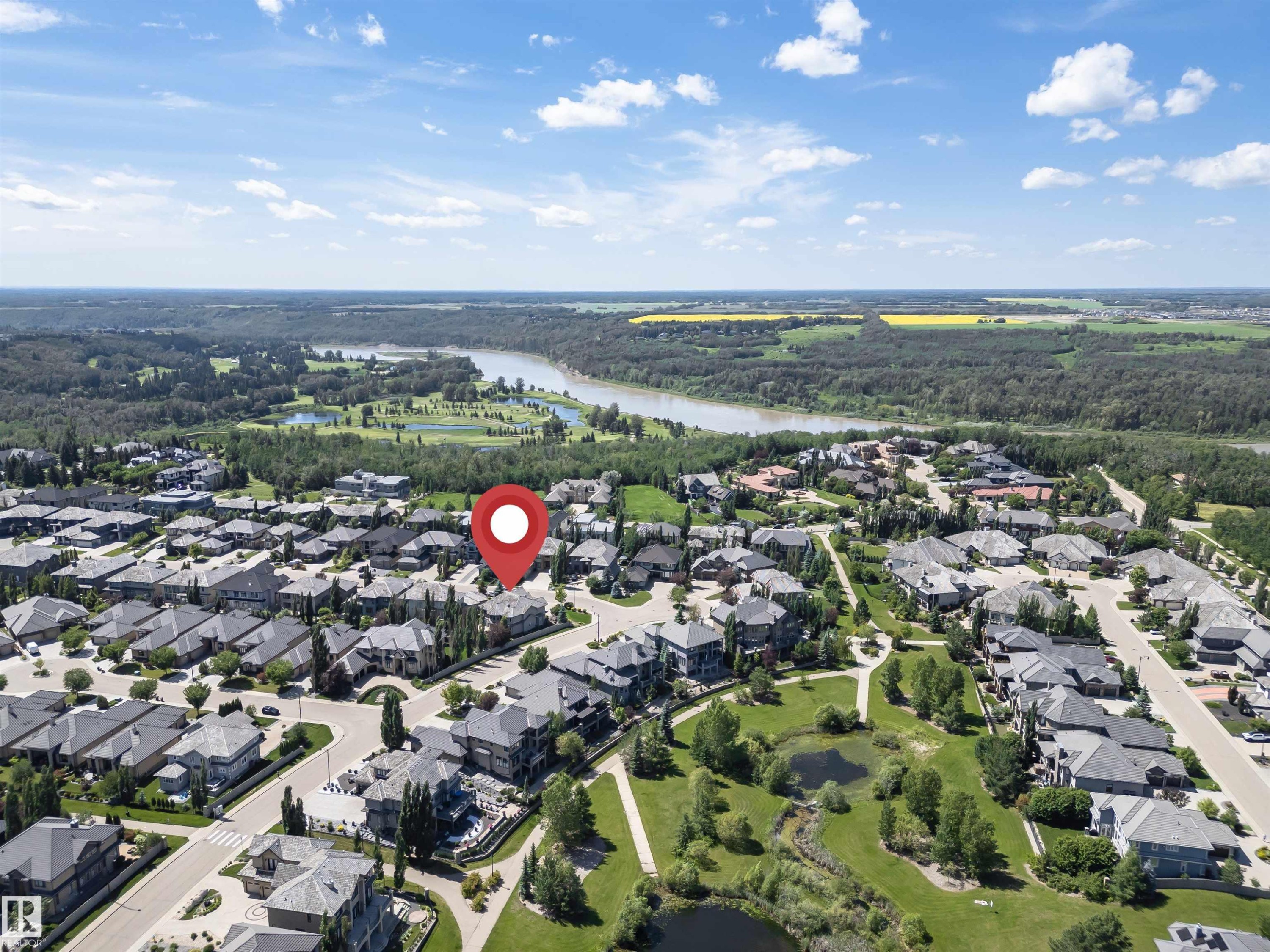 Residential area with a river backdrop, surrounded by dense green forest and agricultural fields - 3503 Watson Point(E), Edmonton, AB