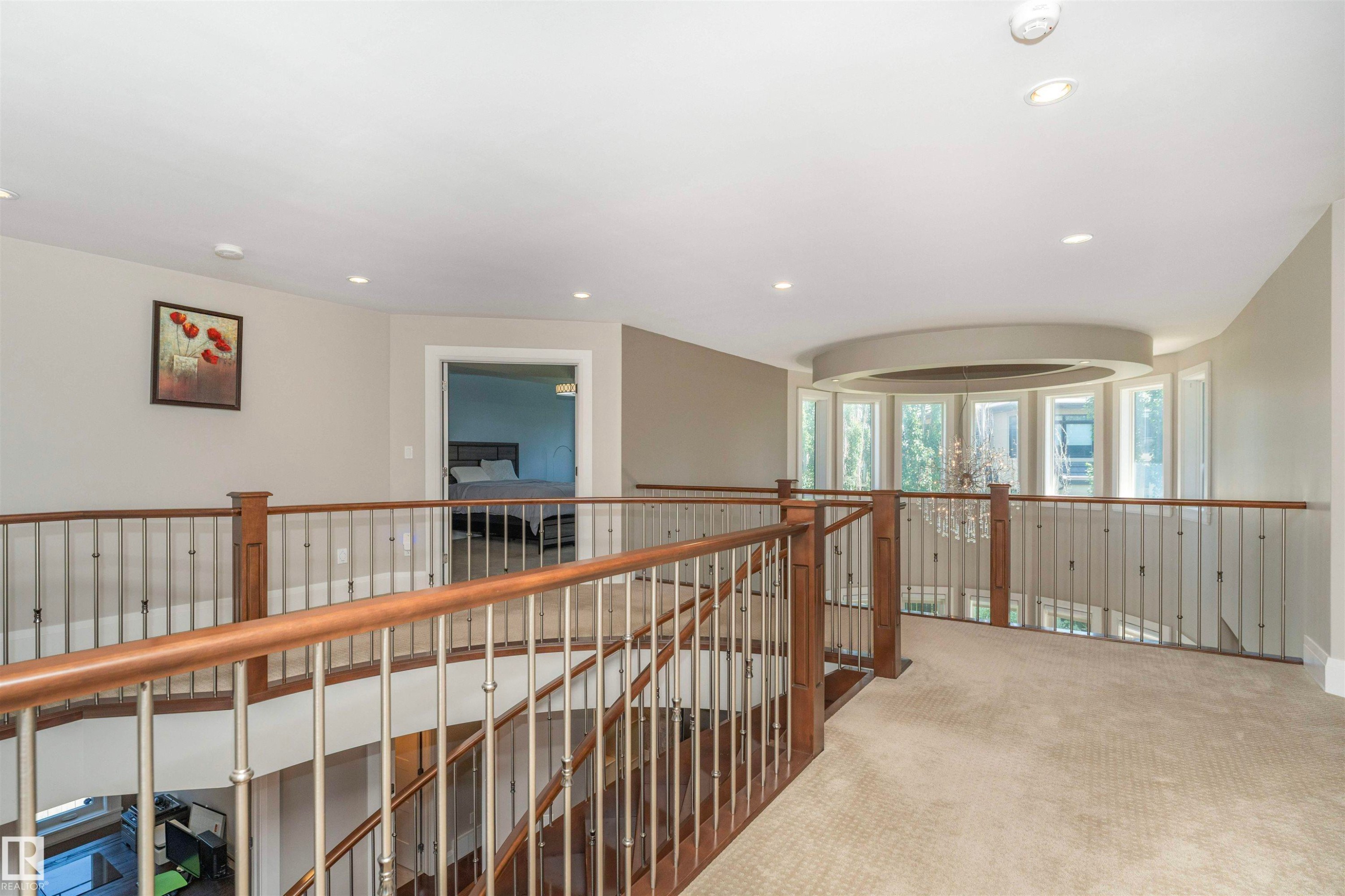 Upper-level landing featuring a curved bay window with multiple panes, recessed lighting, and light-toned carpet flooring - 3503 Watson Point(E), Edmonton, AB