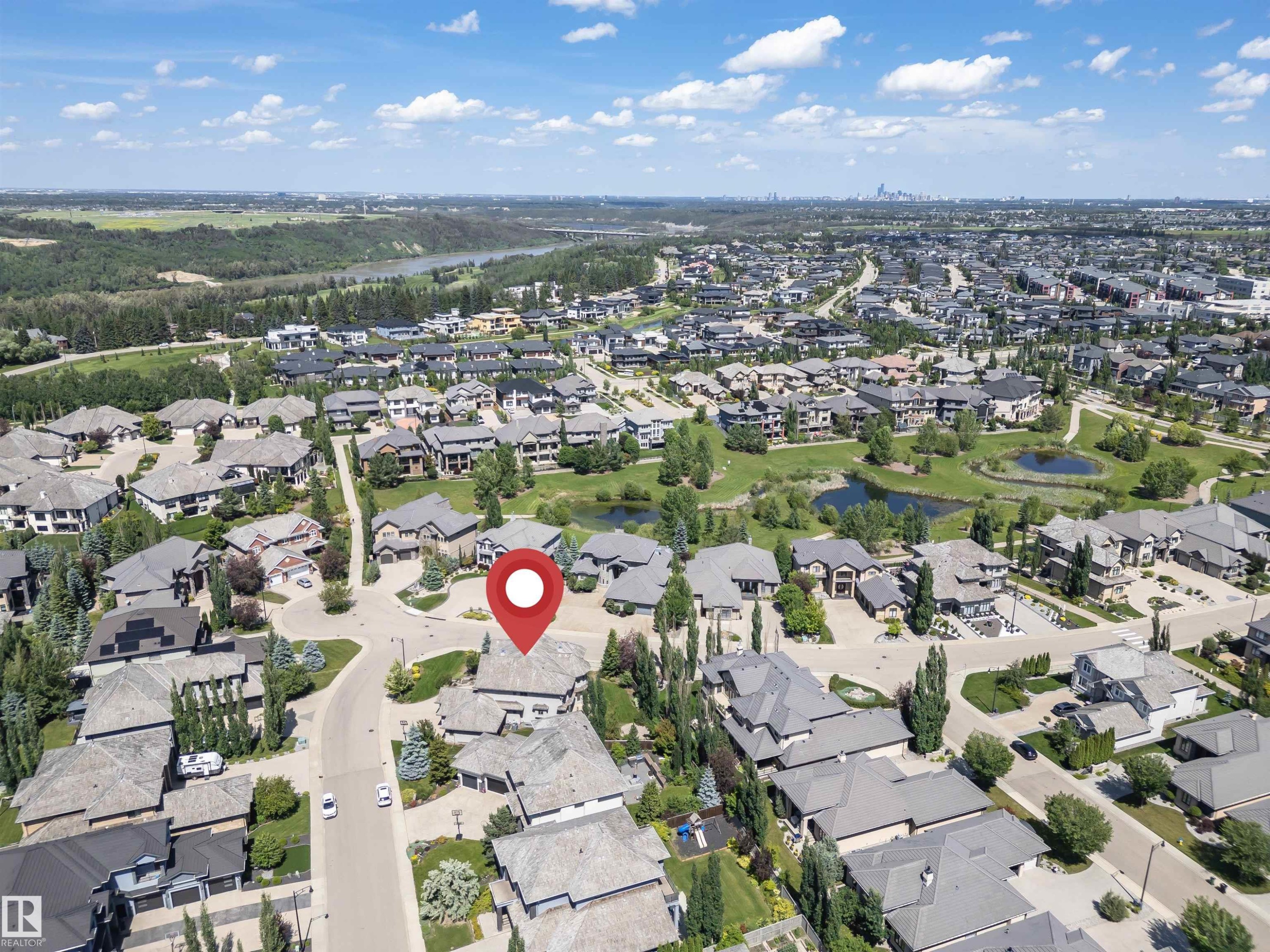 Aerial perspective of a residential community featuring diverse housing styles, mature trees, and a curvilinear street layout - 3503 Watson Point(E), Edmonton, AB