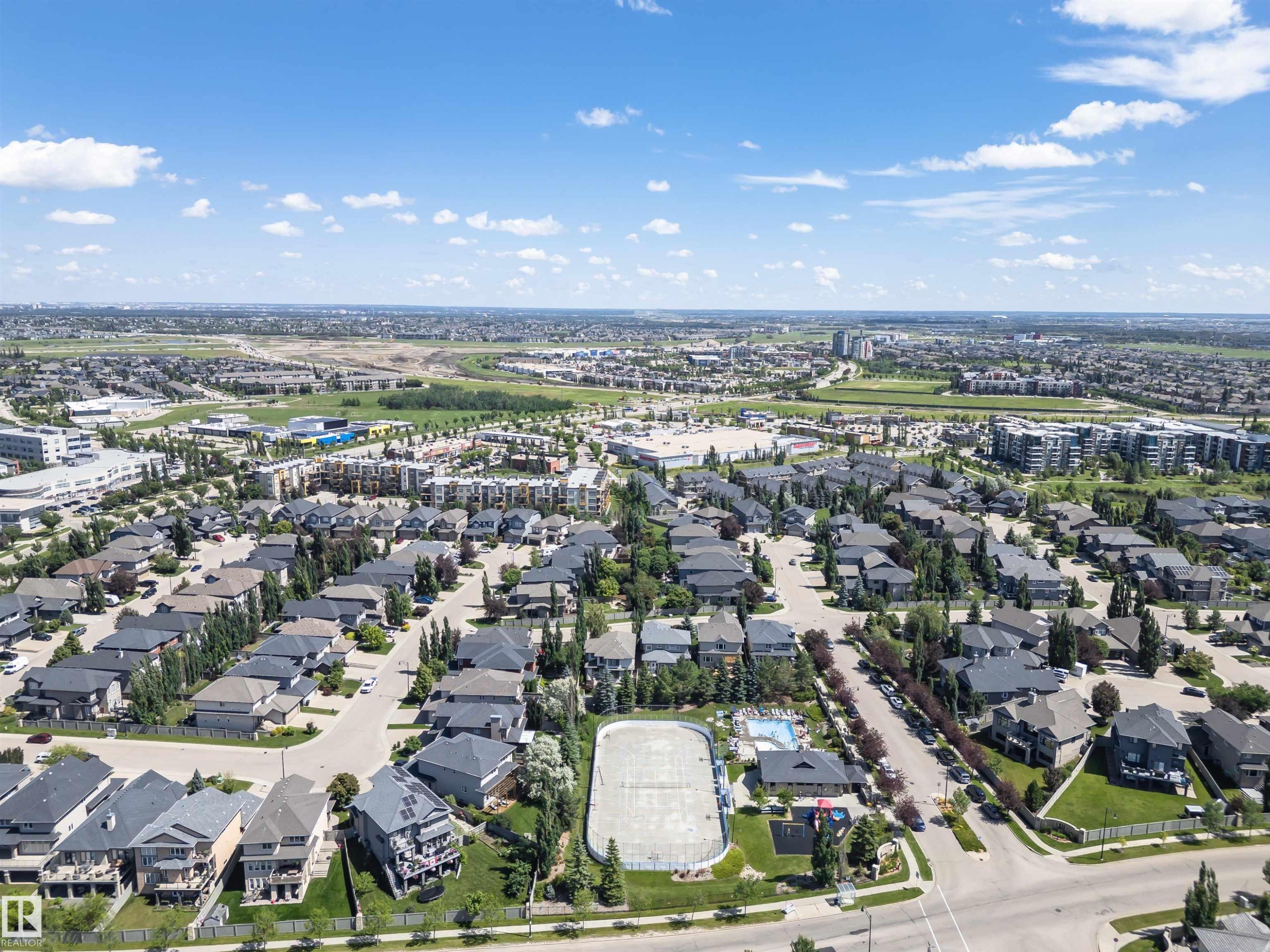 Expansive aerial depicting a residential neighborhood with numerous detached homes, street infrastructure, and mature trees - 3503 Watson Point(E), Edmonton, AB
