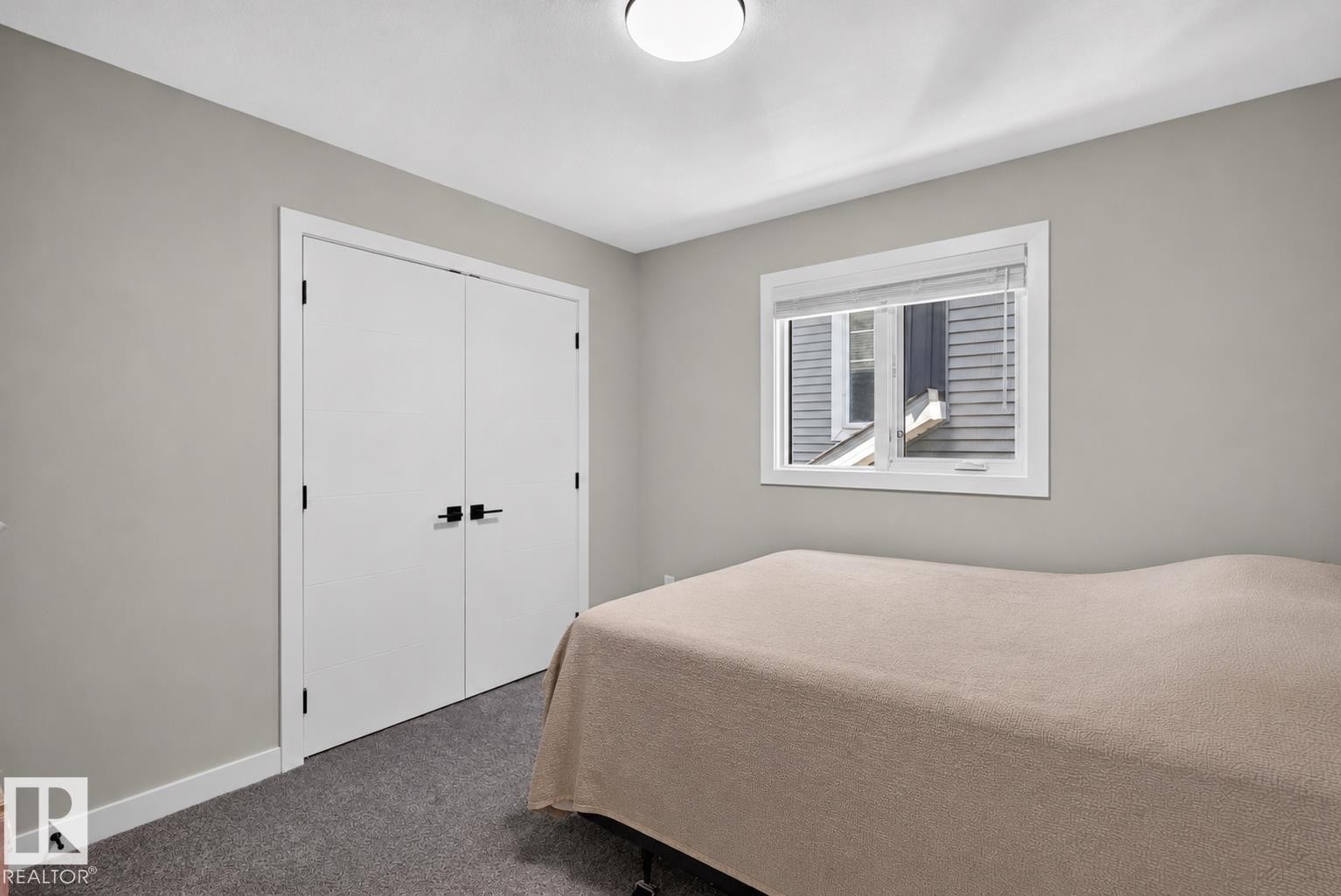 Neutral gray wall paint with white trim, a single window, and a flush-mount ceiling light - 1573 Esaiw Place Nw, Edmonton, AB