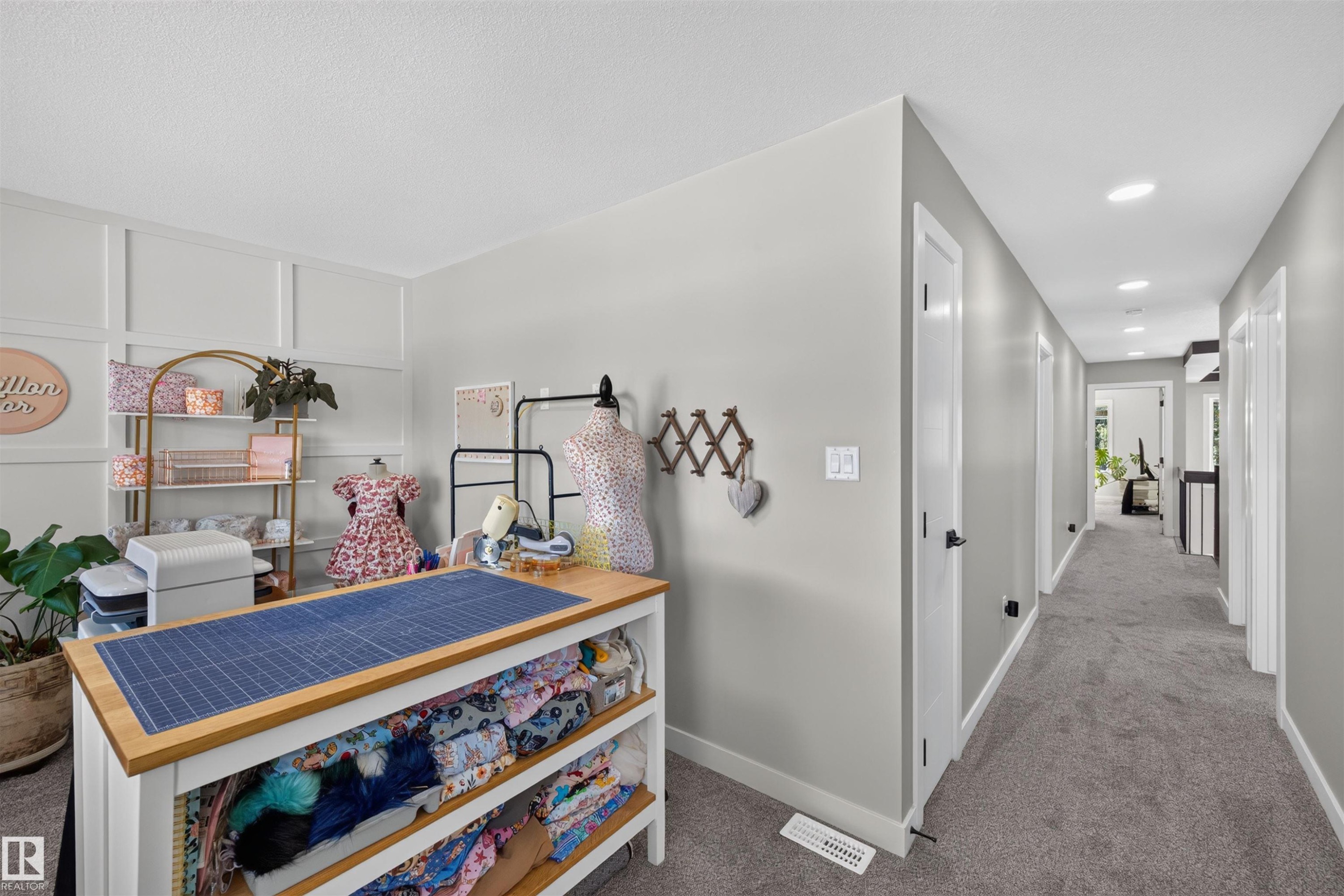 Bright interior space featuring a hallway with carpet flooring and recessed lighting - 1573 Esaiw Place Nw, Edmonton, AB