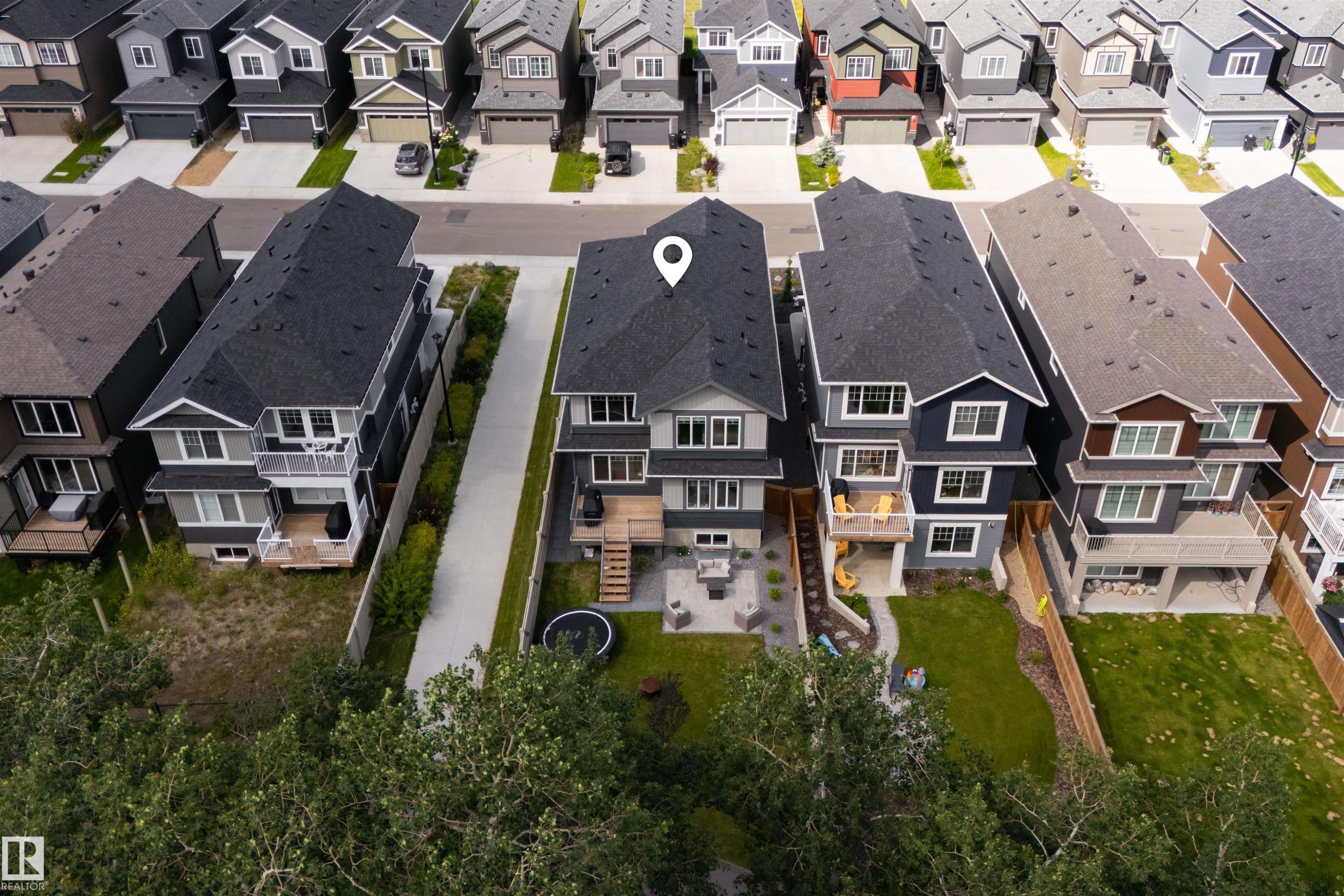 Modern multi-story property featuring a dark shingle roof and a light-colored exterior - 1573 Esaiw Place Nw, Edmonton, AB