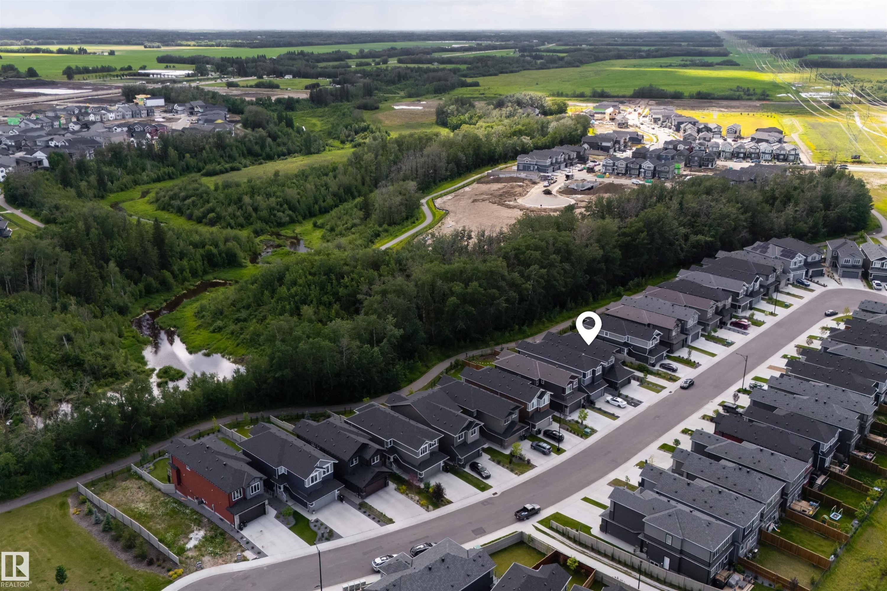 Aerial perspective showcasing a developed residential street with uniform detached homes - 1573 Esaiw Place Nw, Edmonton, AB