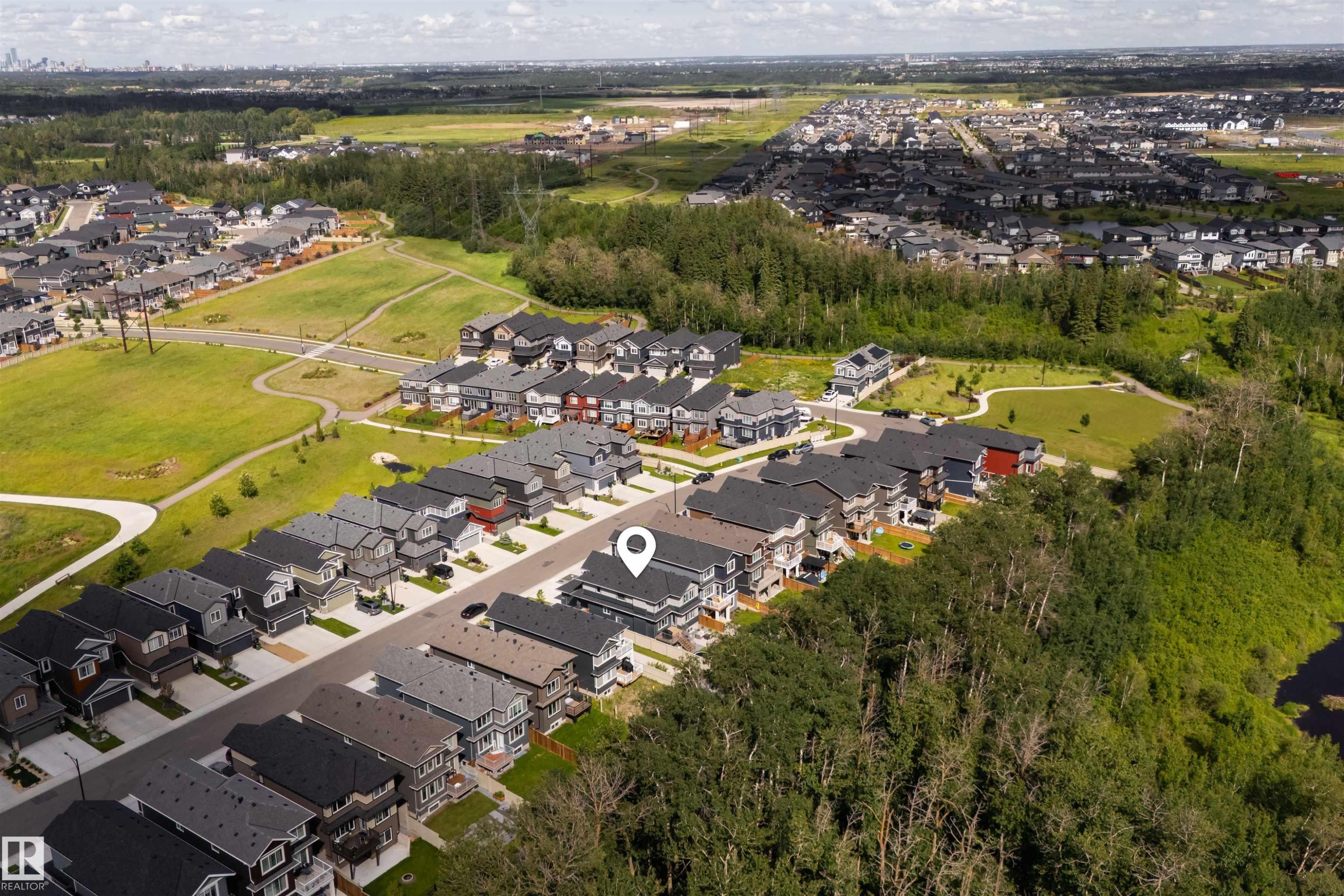Residential community with varied architectural styles, green spaces, and a nearby natural area - 1573 Esaiw Place Nw, Edmonton, AB