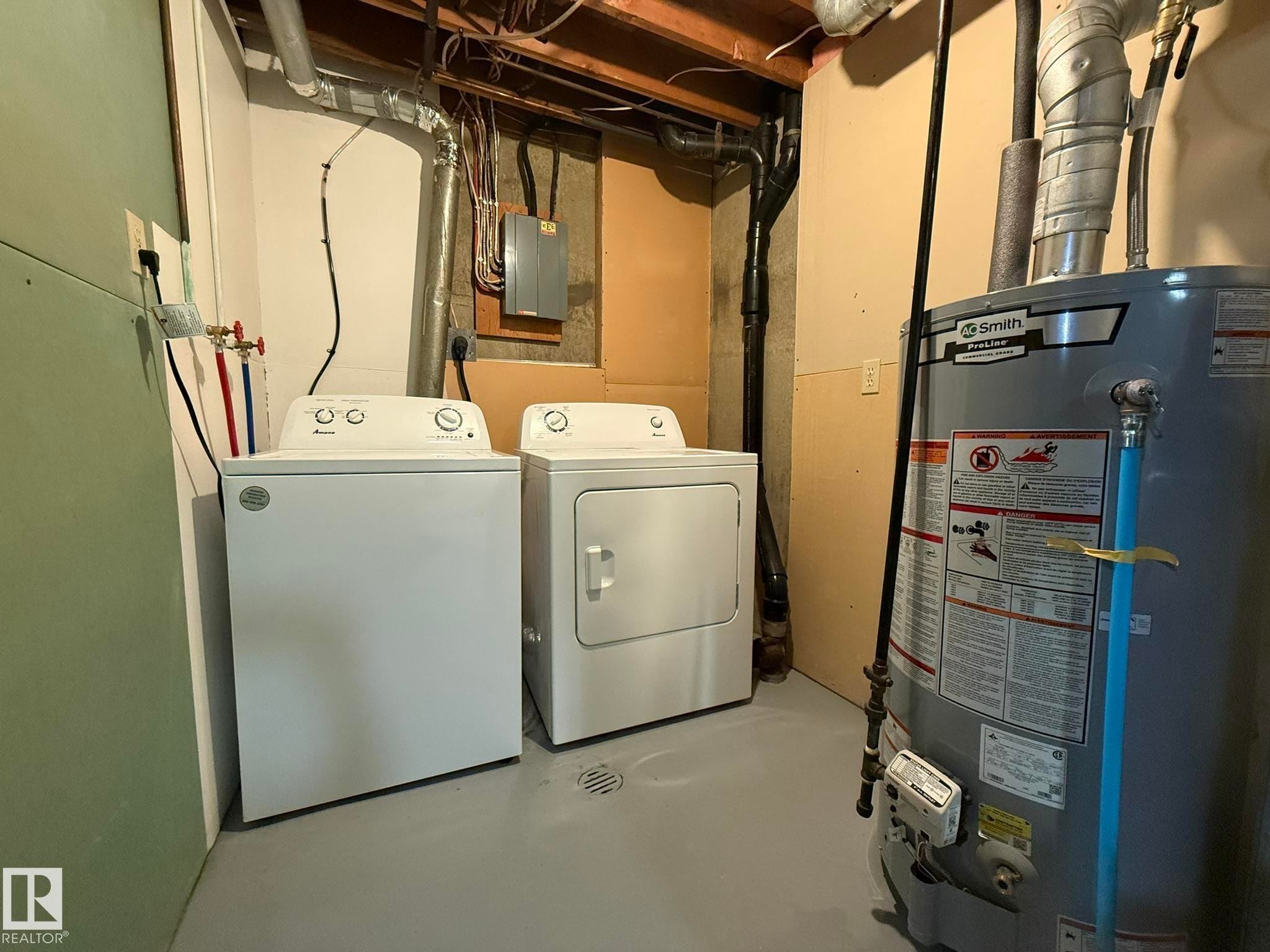 Dedicated utility area featuring a water heater, a washer, and a dryer - 166 Roseland Village, Edmonton, AB - Indoor Photo Showing Laundry Room