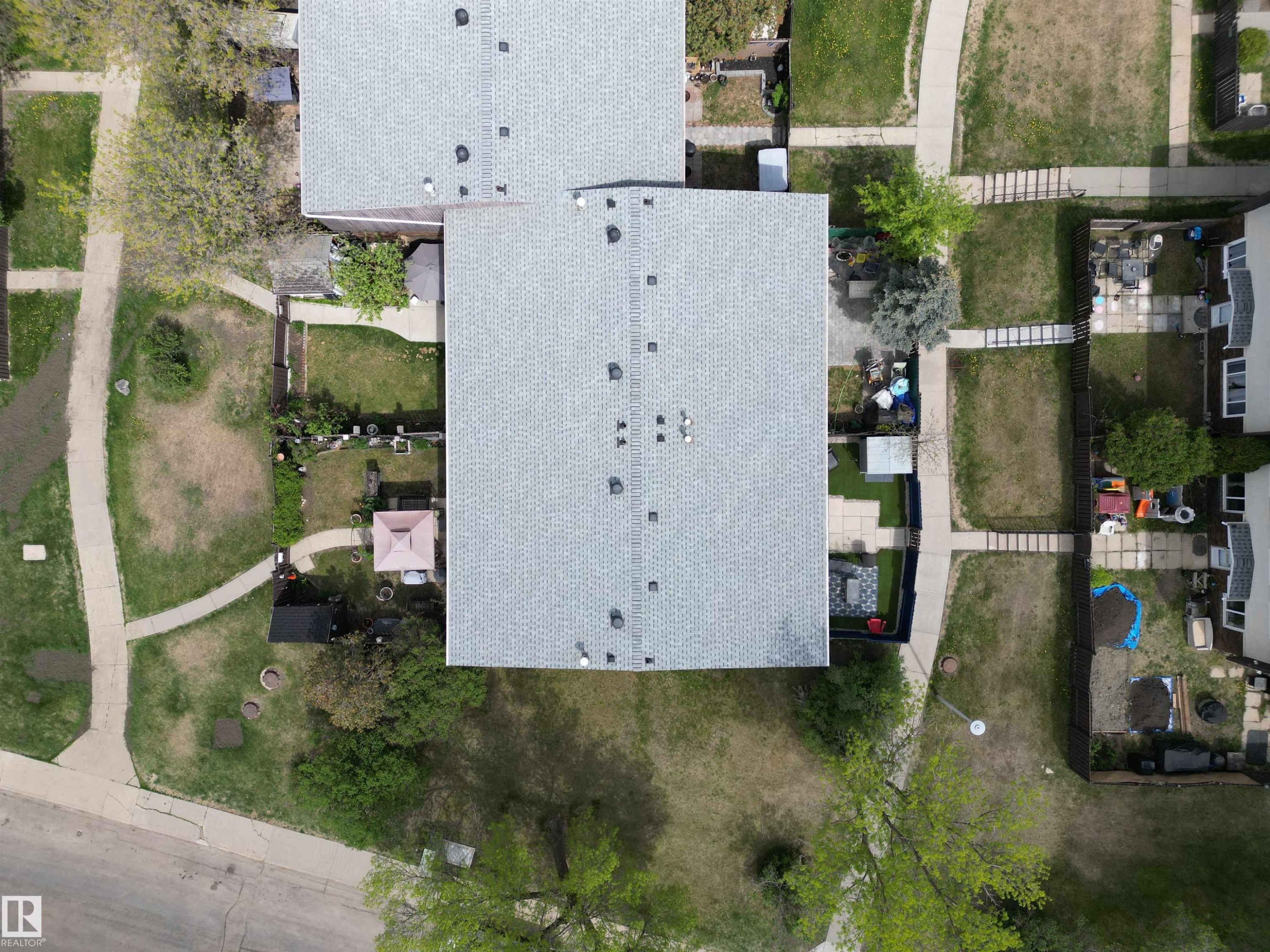 Residential property featuring a grey shingle roof and multiple skylights - 166 Roseland Village, Edmonton, AB - Outdoor