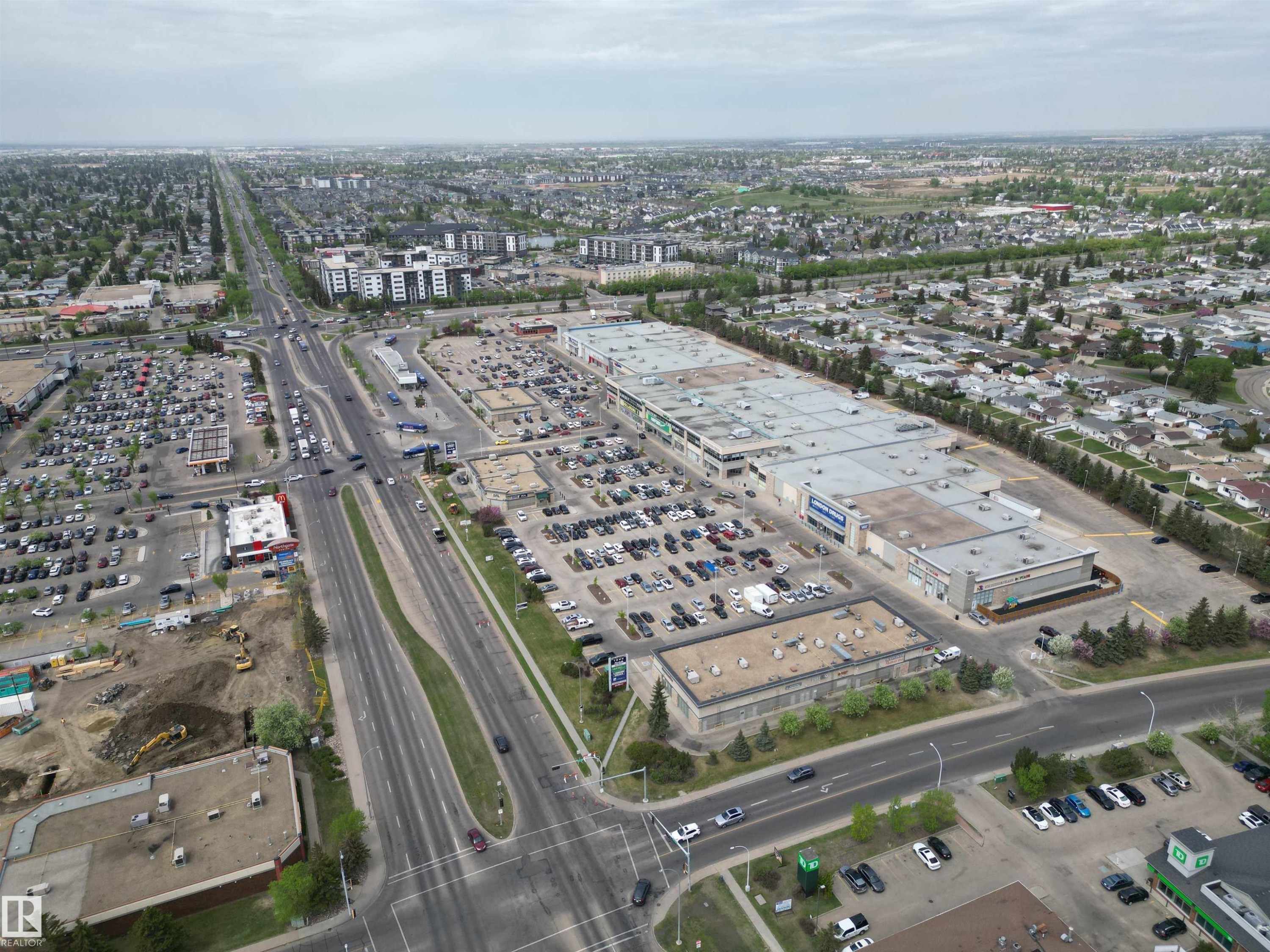 Expansive commercial retail development featuring multiple large-format buildings with extensive surface parking and direct access to a major thoroughfare - 166 Roseland Village, Edmonton, AB - Outdoor With View