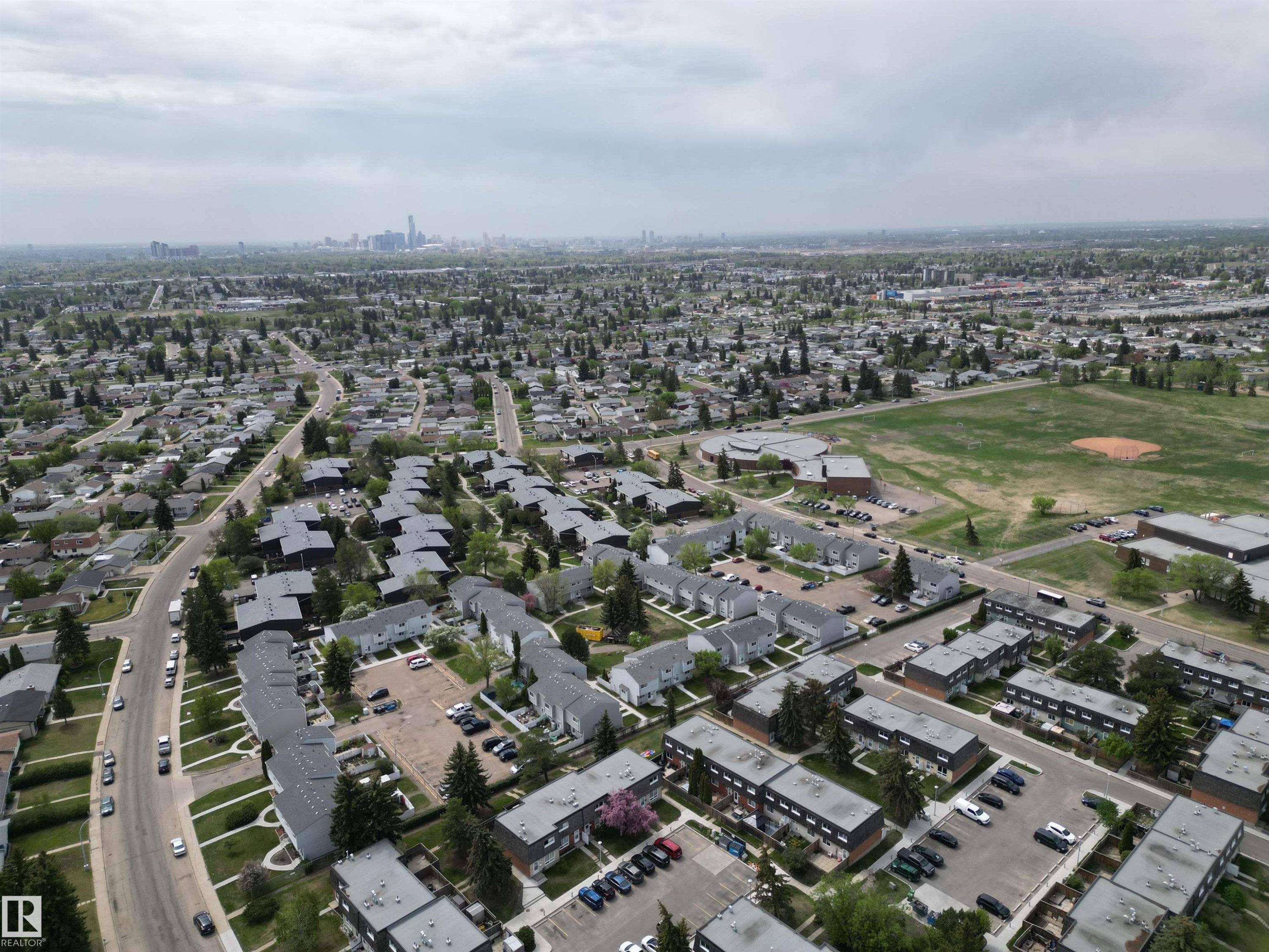 Aerial perspective showcasing varied residential architecture including single-family homes and multi-unit complexes - 166 Roseland Village, Edmonton, AB - Outdoor With View