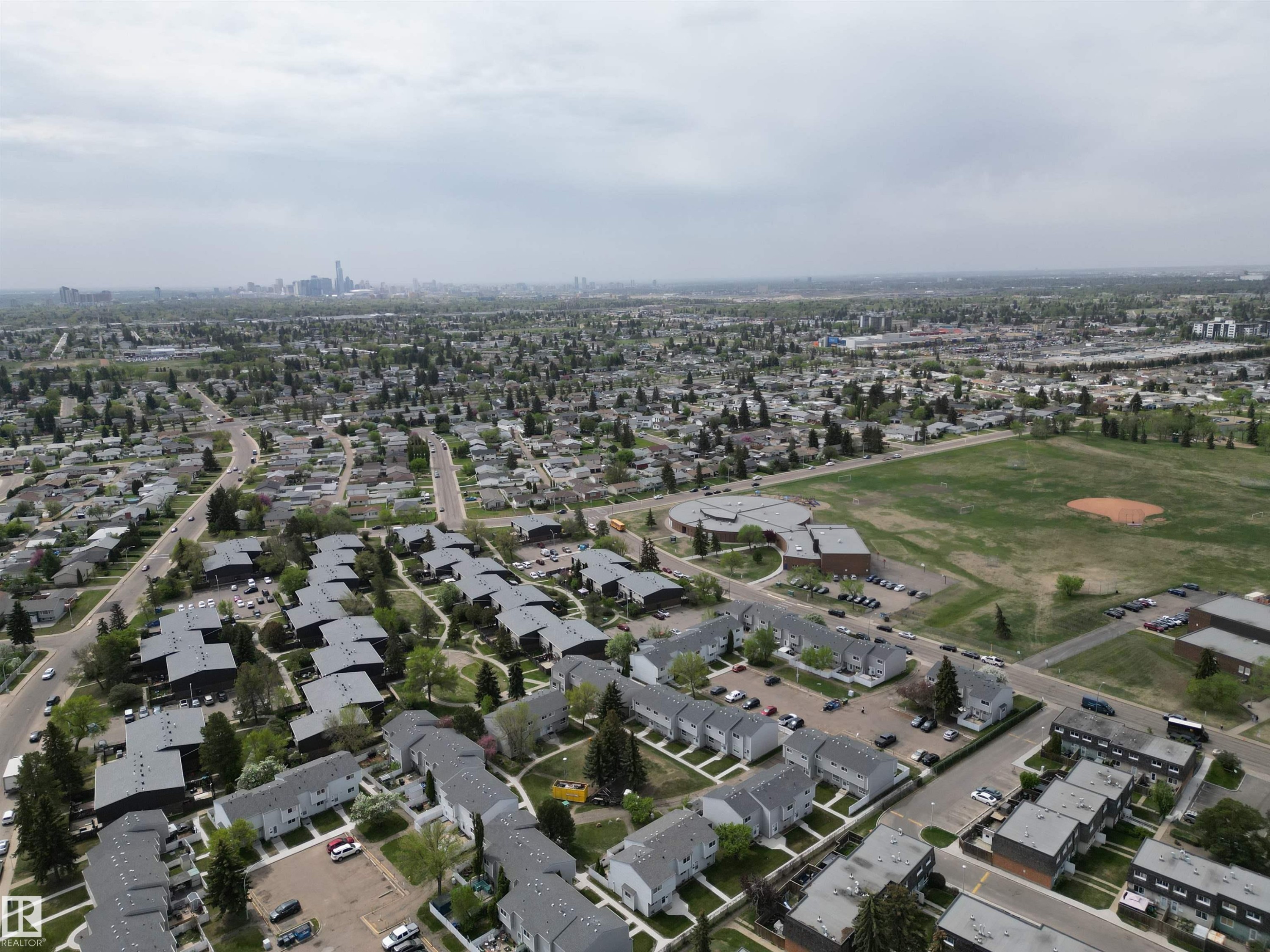 Expansive aerial perspective showcasing a residential neighborhood with varied housing styles - 166 Roseland Village, Edmonton, AB - Outdoor With View