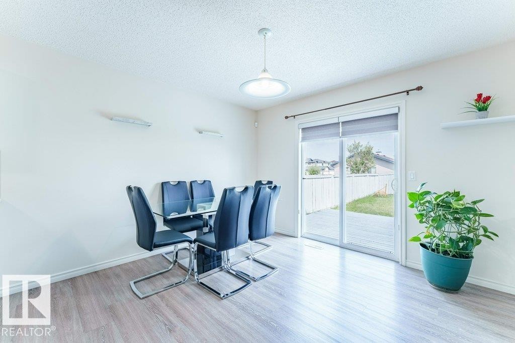 Light wood-finish flooring complements the neutral wall color - 3525 22 Street, Edmonton, AB - Indoor