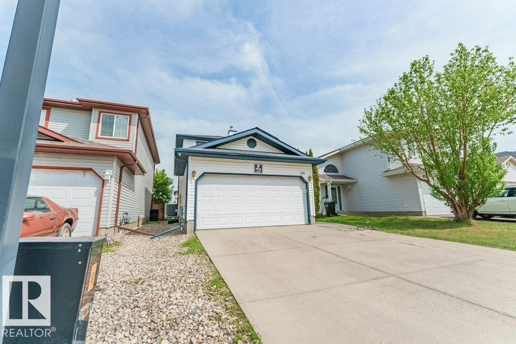 Front exterior showcasing a two-story residence with light-colored siding and dark trim - 3525 22 Street, Edmonton, AB - Outdoor