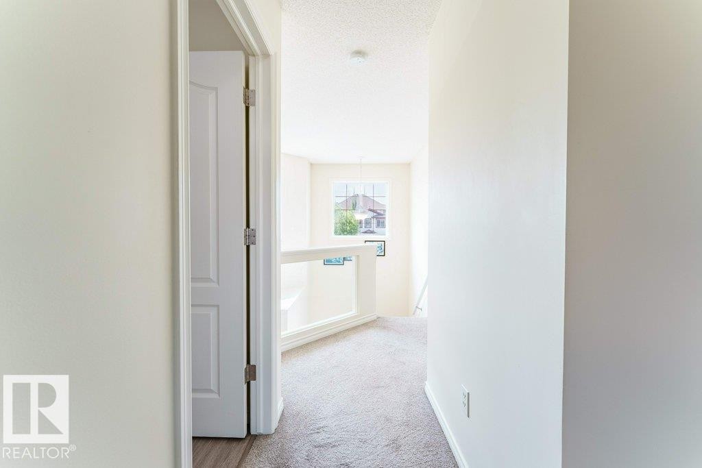 Upper-level hallway with neutral carpeting and light-toned wall finishes - 3525 22 Street, Edmonton, AB - Indoor Photo Showing Other Room