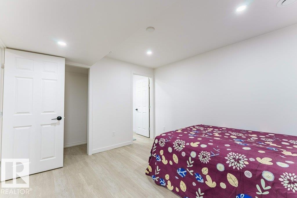 Room featuring recessed lighting, light wood-finish flooring, white walls, and white paneled doors - 3525 22 Street, Edmonton, AB - Indoor Photo Showing Bedroom