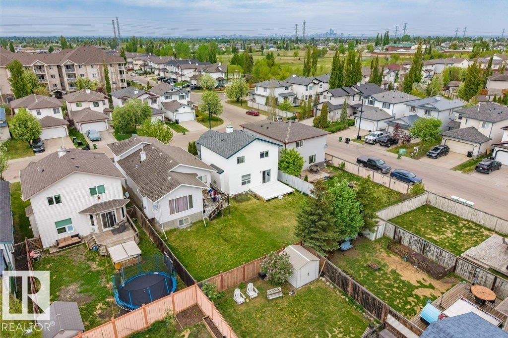 Expansive residential property featuring a large backyard, a white exterior, and a rear deck - 3525 22 Street, Edmonton, AB - Outdoor With View