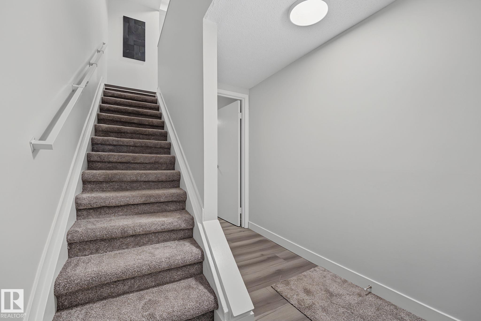 Stairs to main level. - 661 Abbottsfield Road Nw, Edmonton, AB - Indoor Photo Showing Other Room