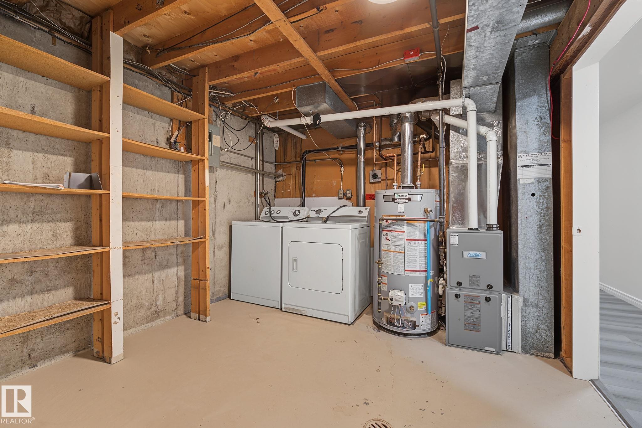 Laundry area with new furnace and hotwater tank. - 661 Abbottsfield Road Nw, Edmonton, AB - Indoor Photo Showing Laundry Room
