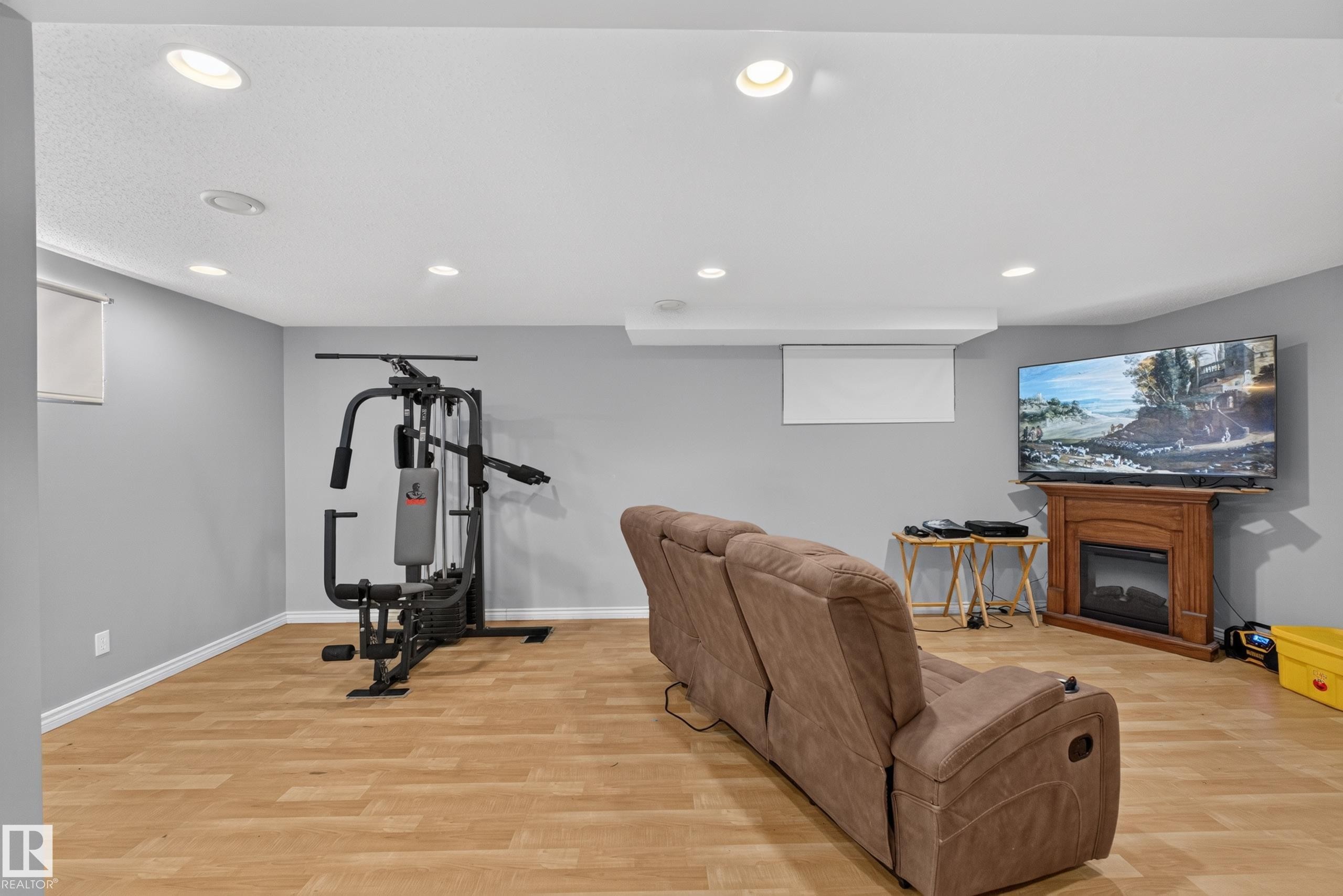 Lower level room featuring wood-finish flooring, recessed lighting, and light gray wall paint - 2327 37B Avenue, Edmonton, AB