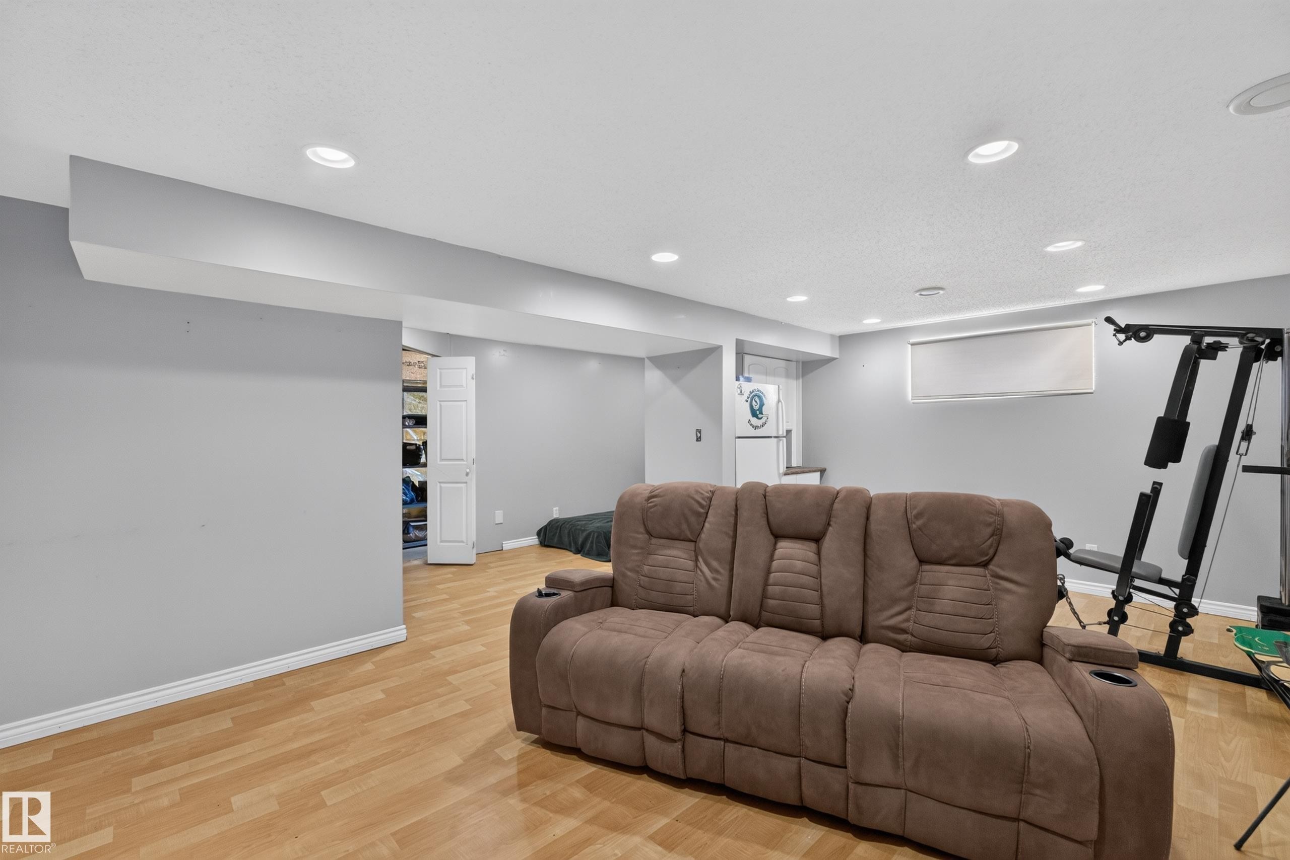 Spacious room with recessed lighting, light wood-finish flooring, and light gray walls - 2327 37B Avenue, Edmonton, AB