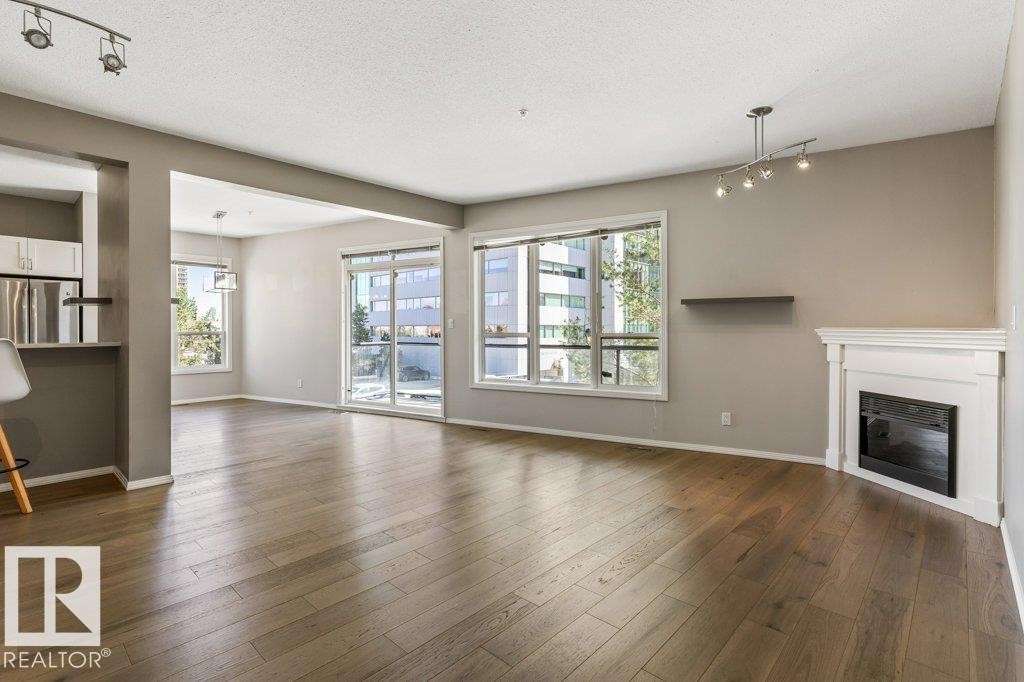 #202 10033 110 St Nw, Edmonton, AB - Indoor Photo Showing Living Room With Fireplace