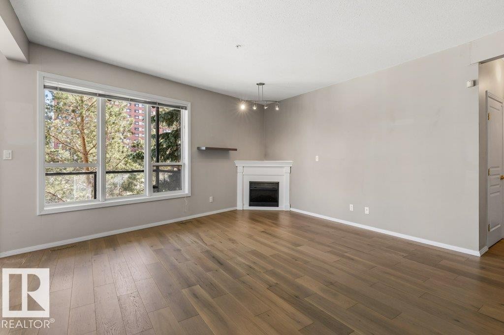 #202 10033 110 St Nw, Edmonton, AB - Indoor Photo Showing Living Room With Fireplace