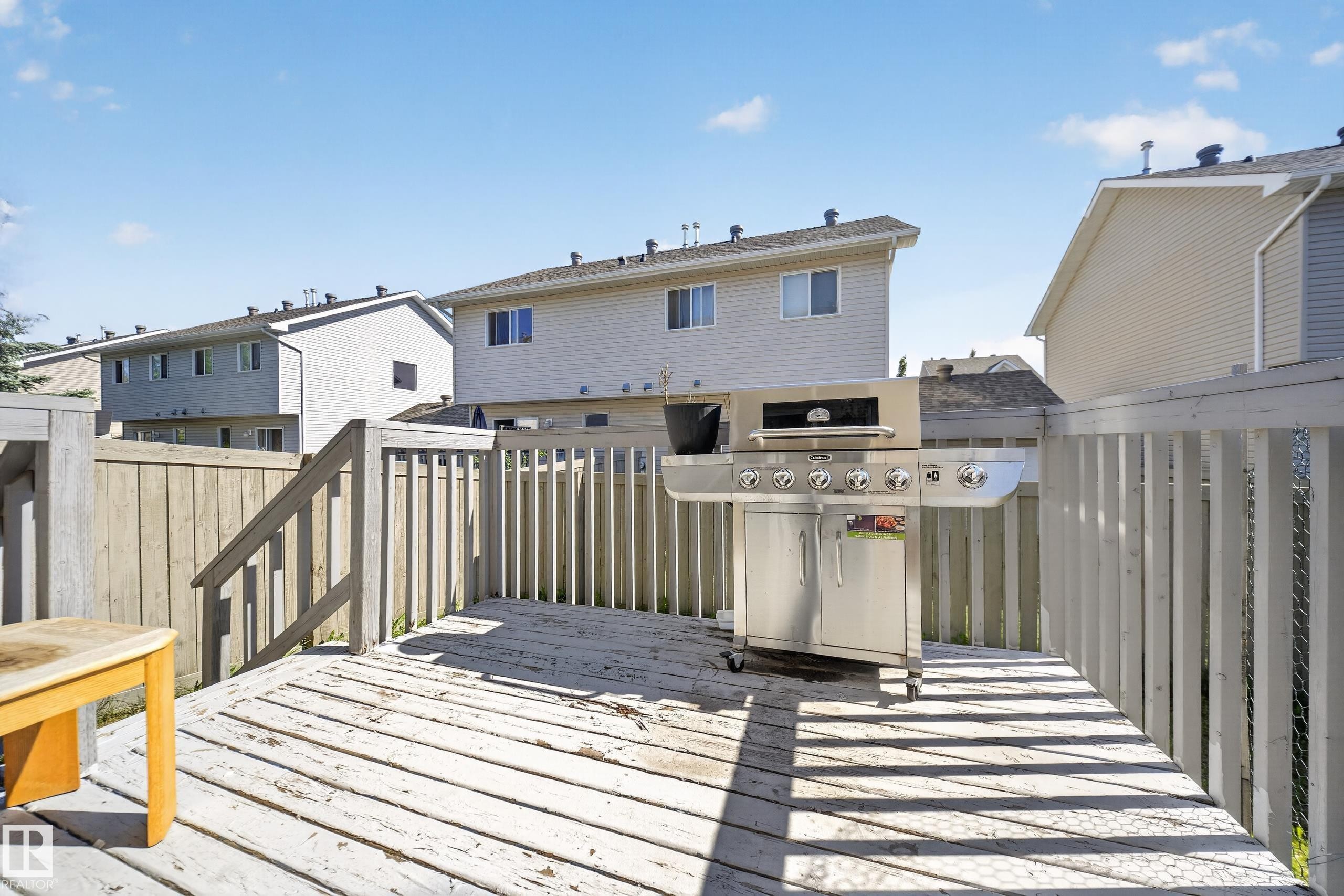 Expansive outdoor deck featuring wood flooring and a perimeter railing - 59 2503 24 Street, Edmonton, AB