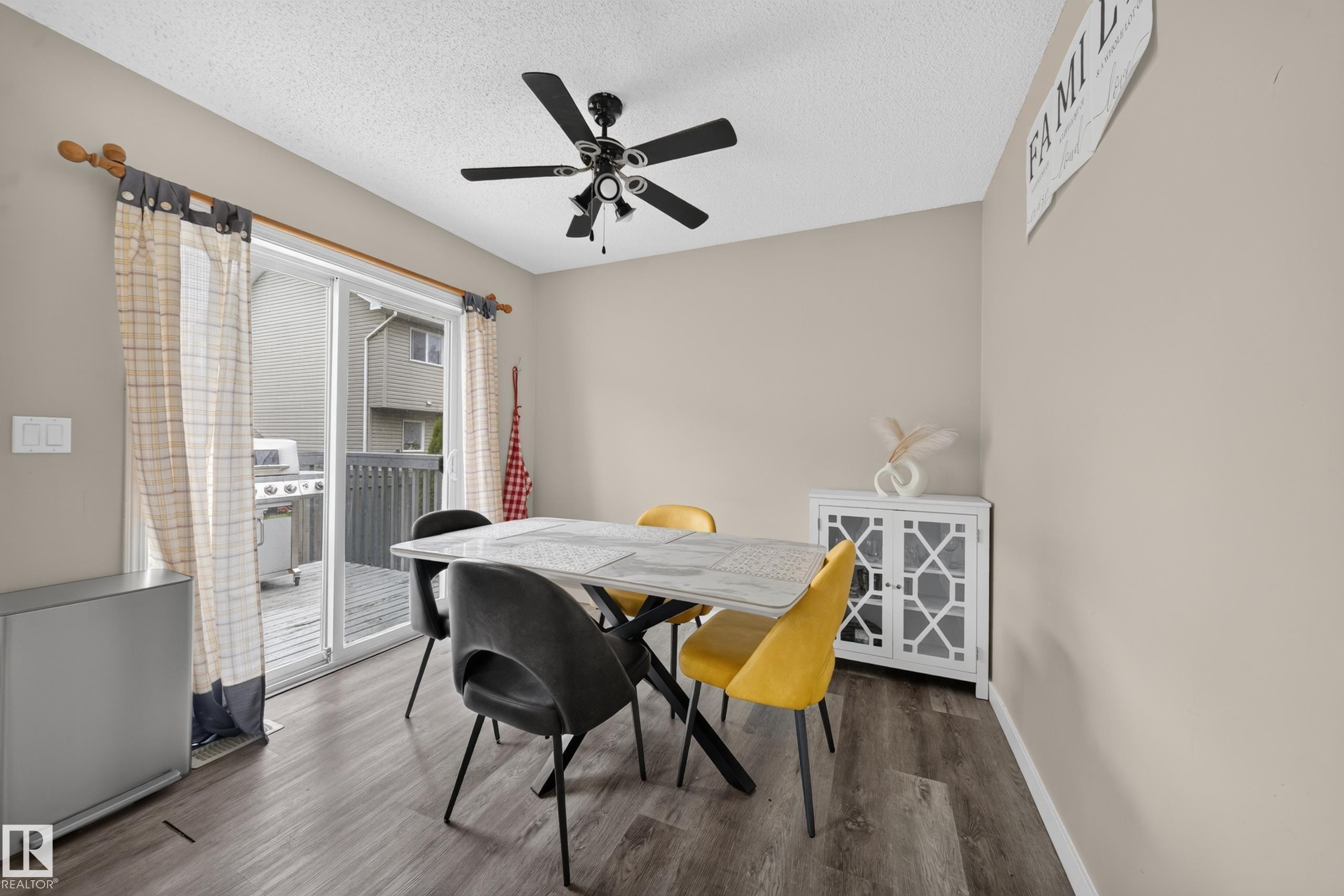 Dining area featuring wood-finish flooring and neutral wall tones - 59 2503 24 Street, Edmonton, AB