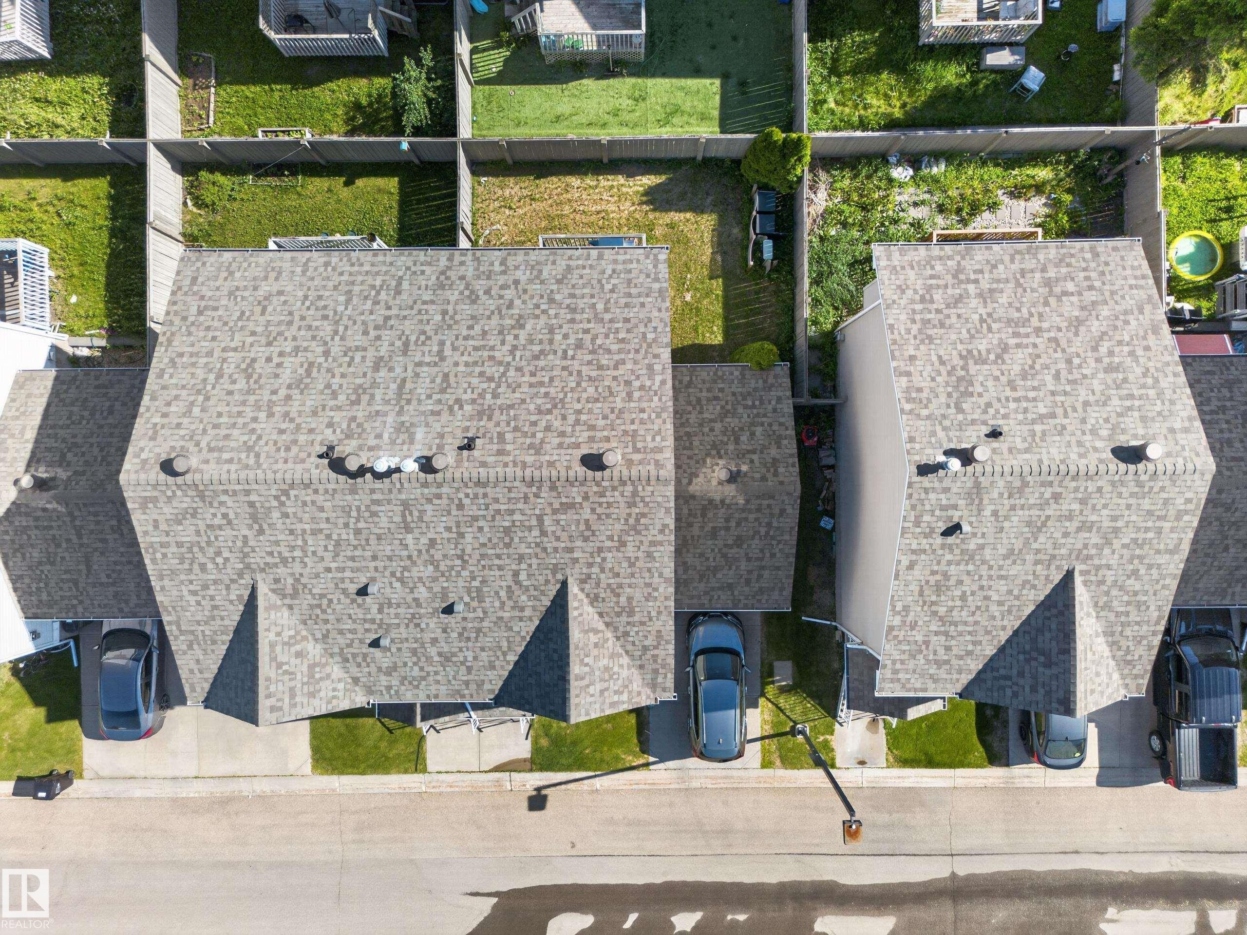 Asphalt shingle roof with multiple roof vents, featuring a pitched roofline - 59 2503 24 Street, Edmonton, AB