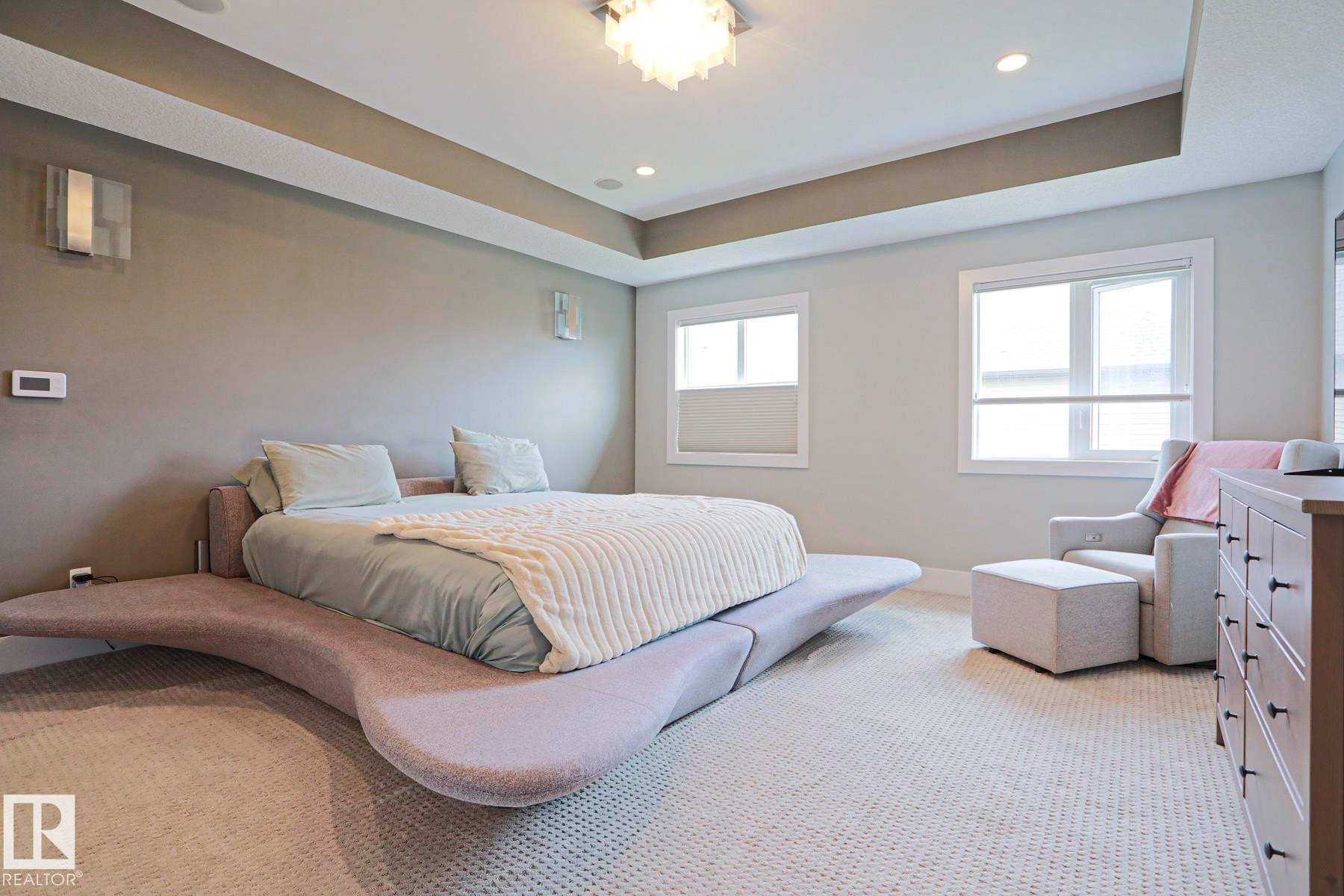 Bedroom featuring recessed lighting, a tray ceiling, and carpeted flooring - 1304 Ainslie Wynd Sw, Edmonton, AB - Indoor Photo Showing Bedroom
