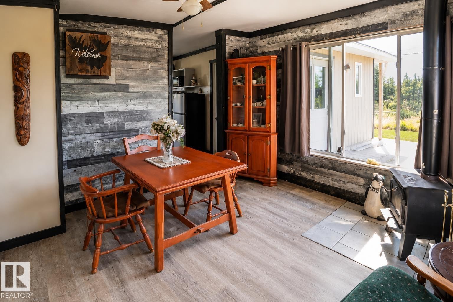 Vaulted wood-paneled ceiling with exposed beams, multiple windows, and a glass-paned exterior door - 315 57201 Rng Rd 102, Rural St. Paul County, AB
