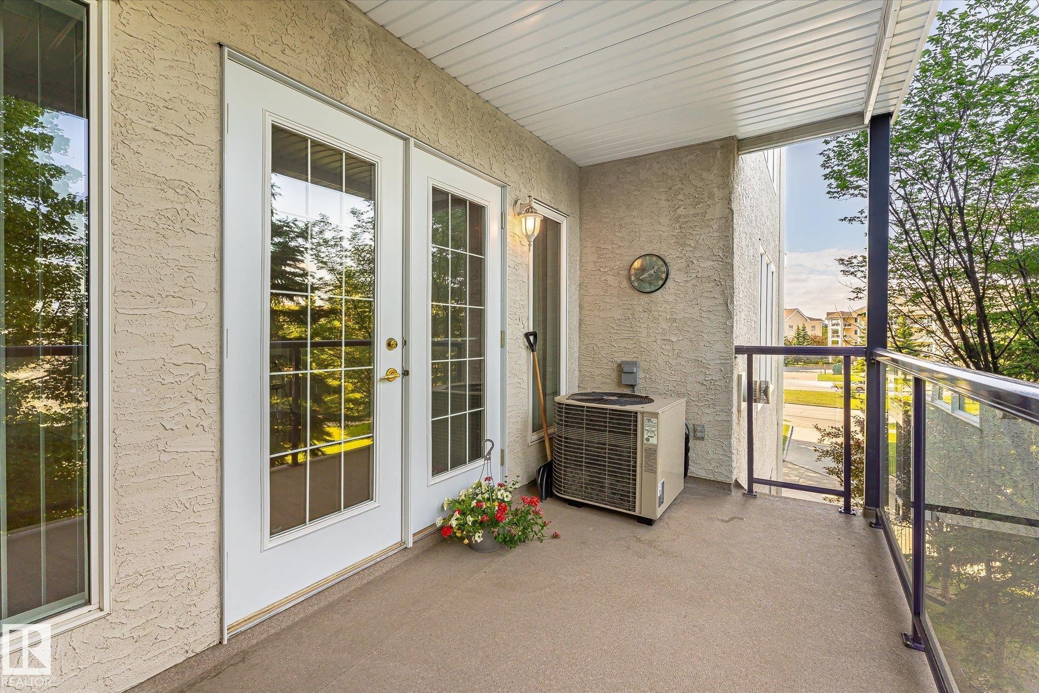Balcony with textured stucco siding, concrete flooring, and a white paneled ceiling - #310 237 Youville Dr E Nw, Edmonton, AB - Outdoor With Balcony With Exterior