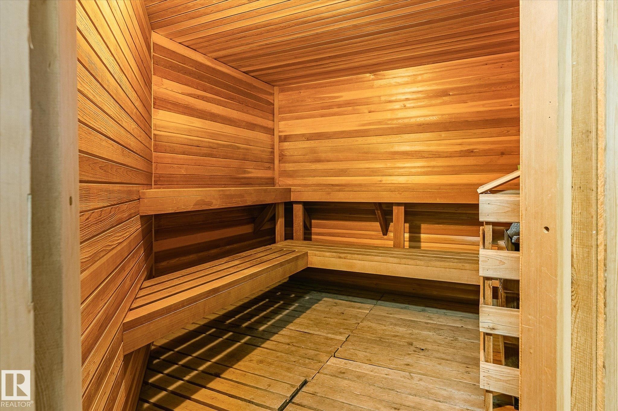 Custom sauna featuring horizontal wood paneling, multi-level wood benches, and slatted wood flooring - #310 237 Youville Dr E Nw, Edmonton, AB - Indoor Photo Showing Other Room