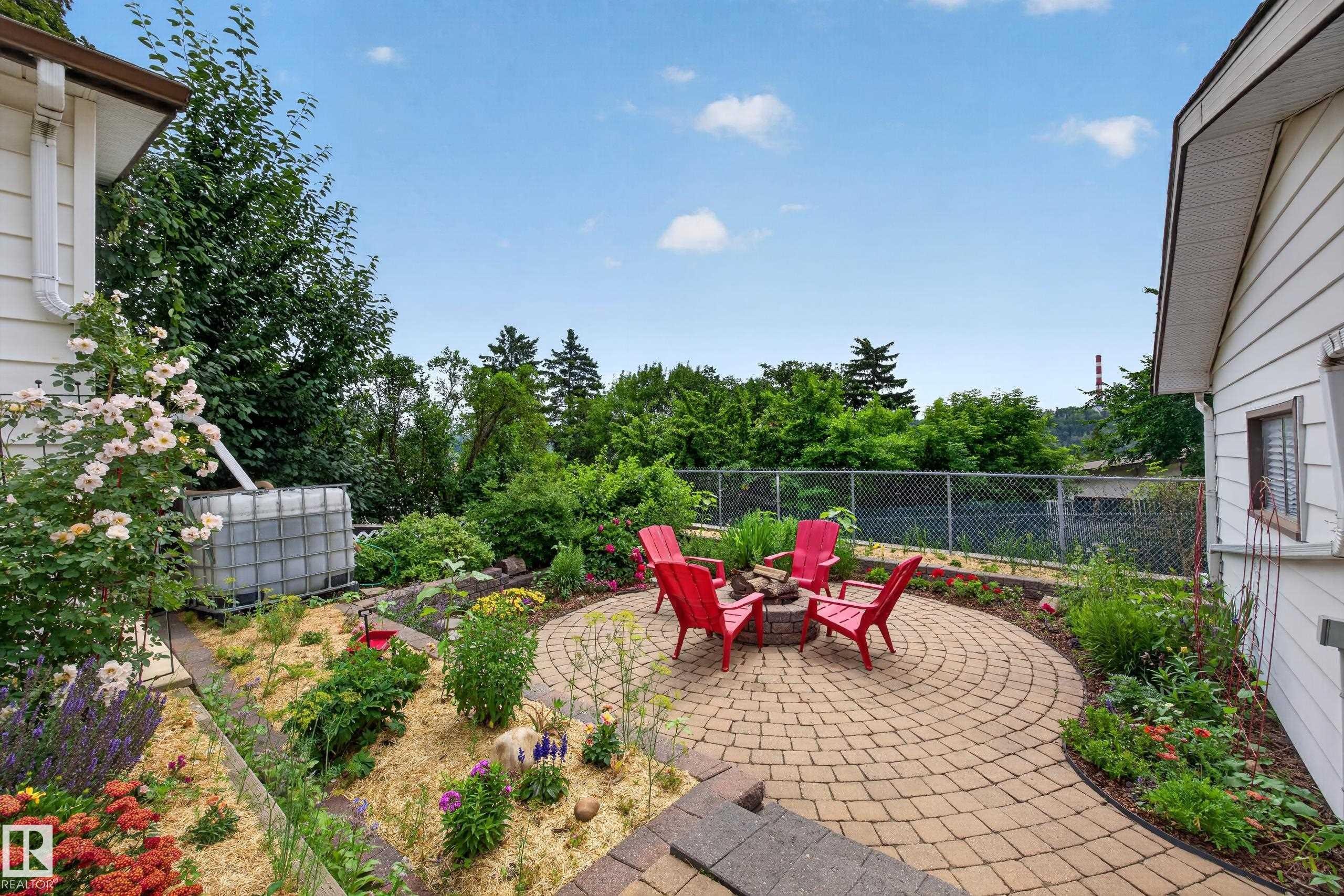 Circular paver patio with a built-in fire pit - 3411 103 Avenue Nw, Edmonton, AB